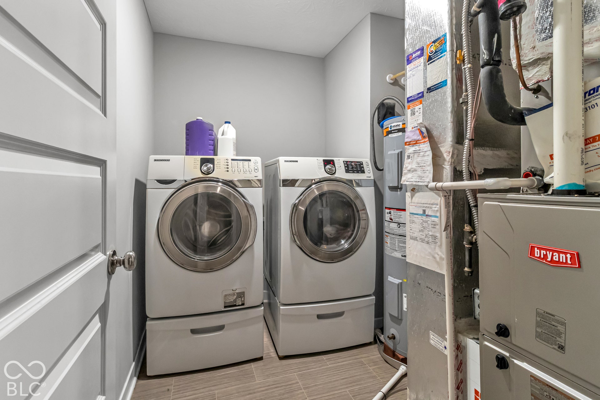Tile flooring, white paneled door, and mechanical equipment