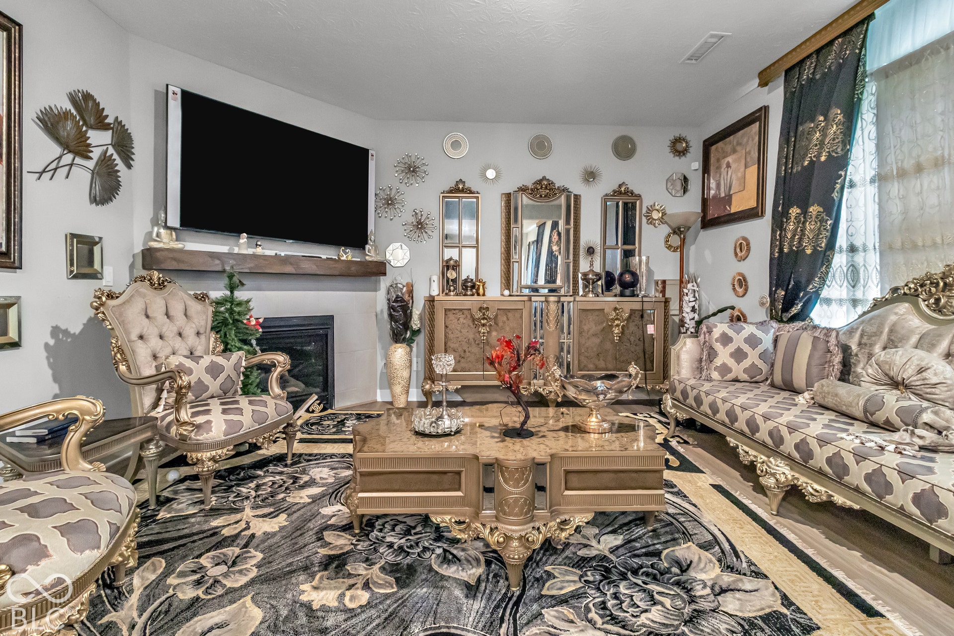 Built-in fireplace with a stone surround, wood mantel, and mounted television