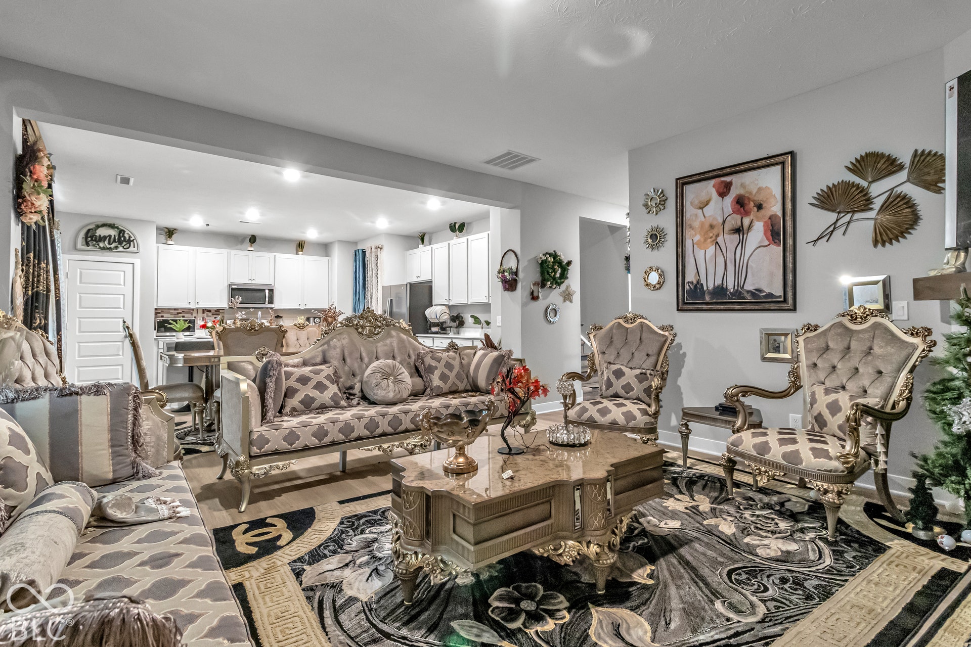 Open-concept living space with light gray walls, recessed lighting, and wood-finish flooring