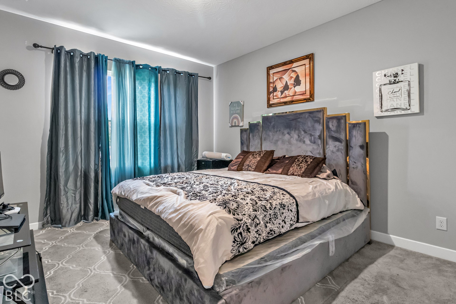 Wall-to-wall carpeting, window with curtain rod, and light gray painted walls