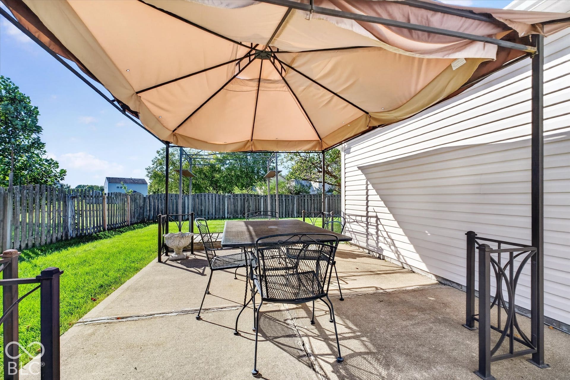 12980 Coyote Run, Fishers, IN 46038 Concrete patio with a privacy fence and manicured lawn