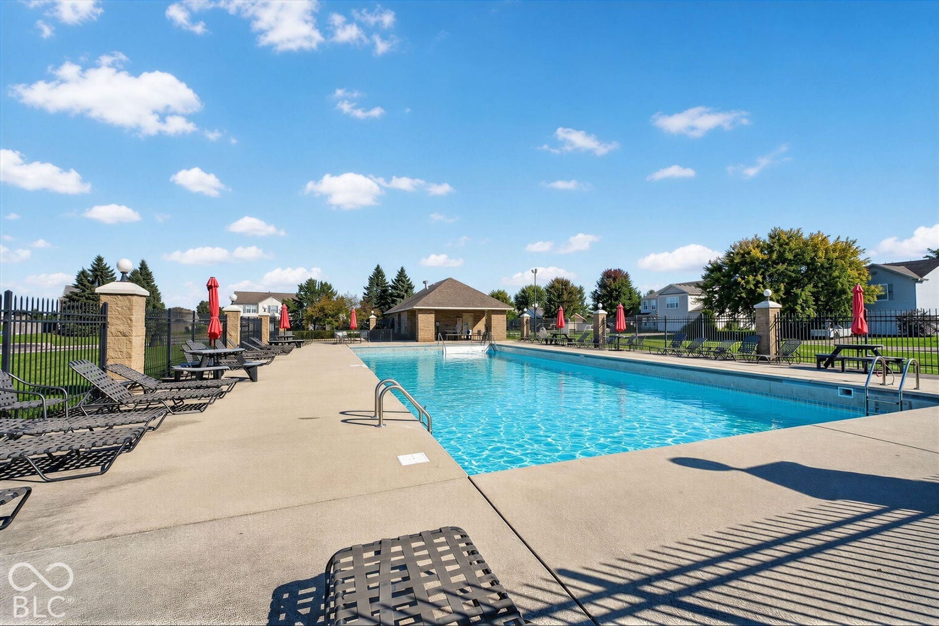 12980 Coyote Run, Fishers, IN 46038 Expansive swimming pool with integrated steps, surrounded by a concrete patio