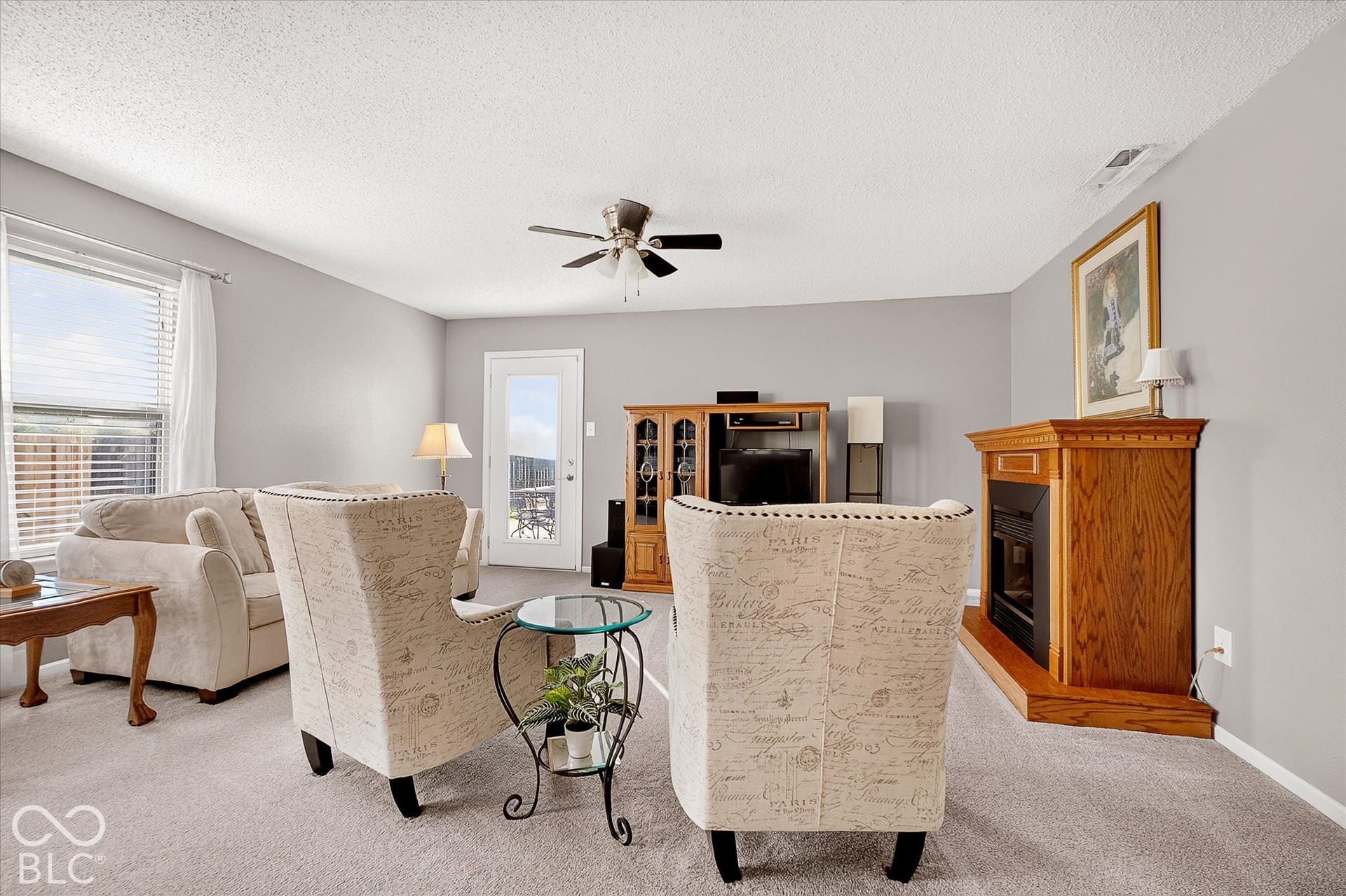 12980 Coyote Run, Fishers, IN 46038 Living area with electric fireplace and leads to the back patio.