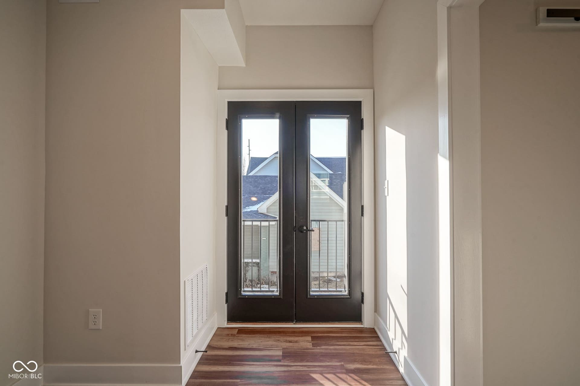 entryway featuring french doors, wood finished floors, and a wall mounted air conditioner