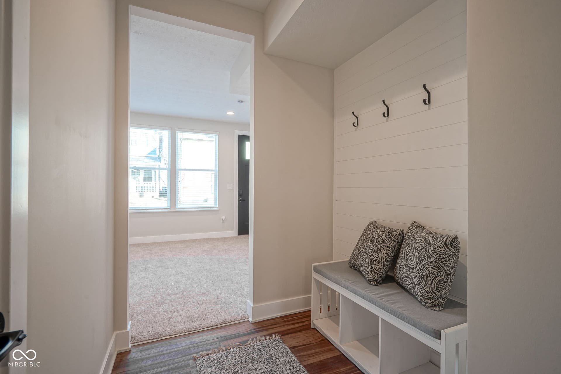 mudroom with wood finished floors and recessed lighting