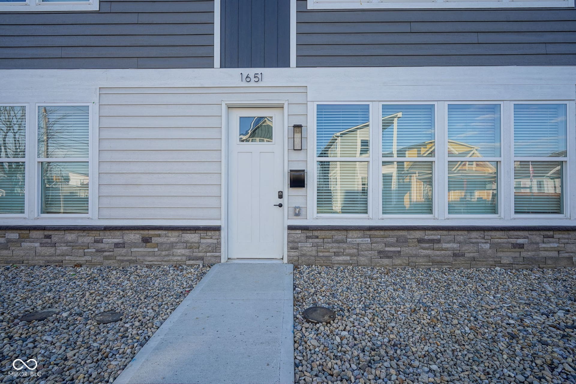 entrance to property featuring stone siding