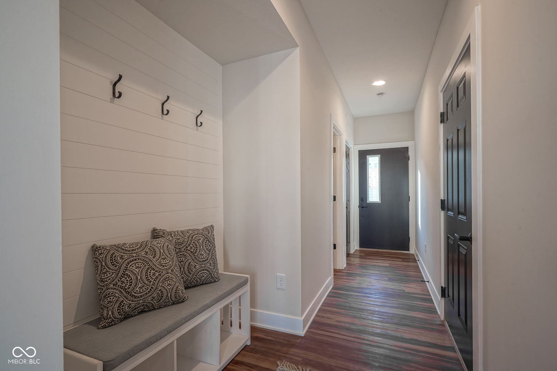 mudroom with dark wood finished floors and recessed lighting
