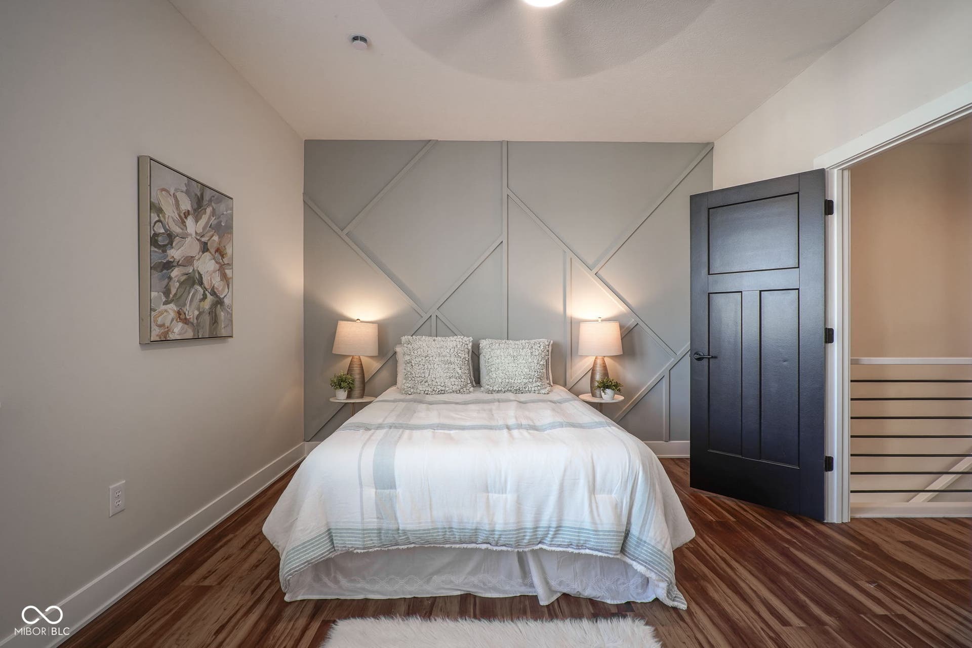 bedroom featuring baseboards and dark wood-style flooring