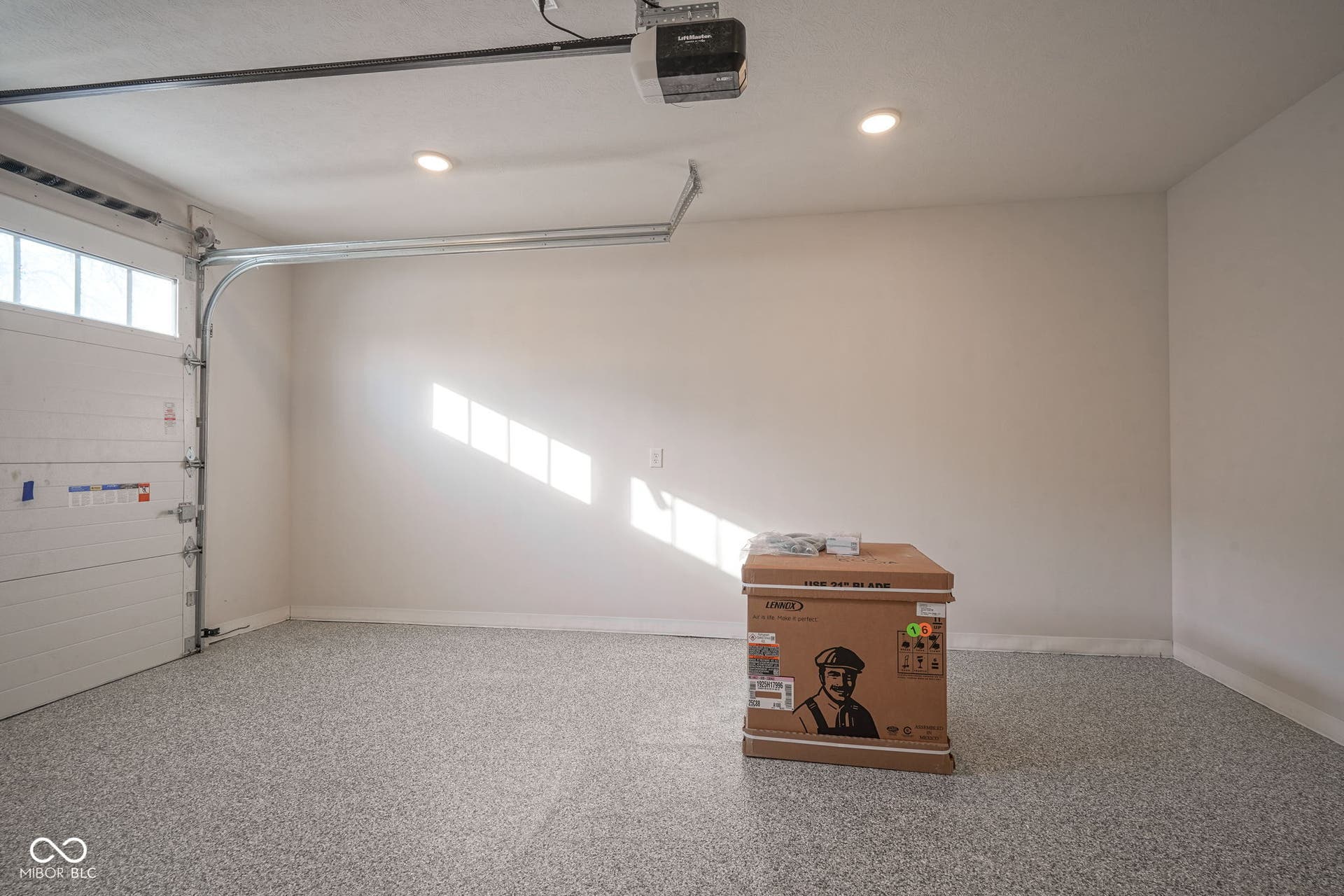 garage featuring a garage door opener and recessed lighting