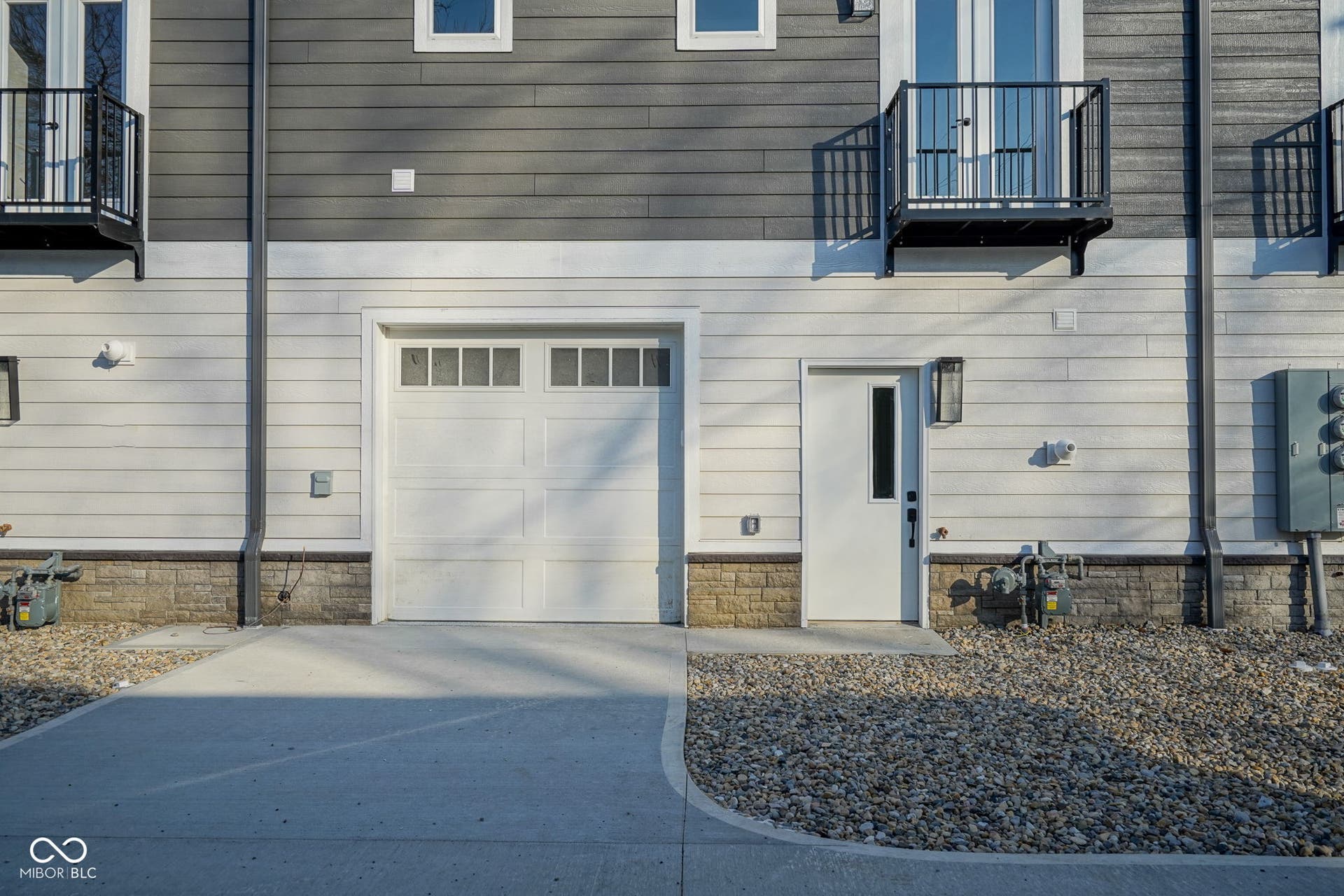 garage featuring concrete driveway