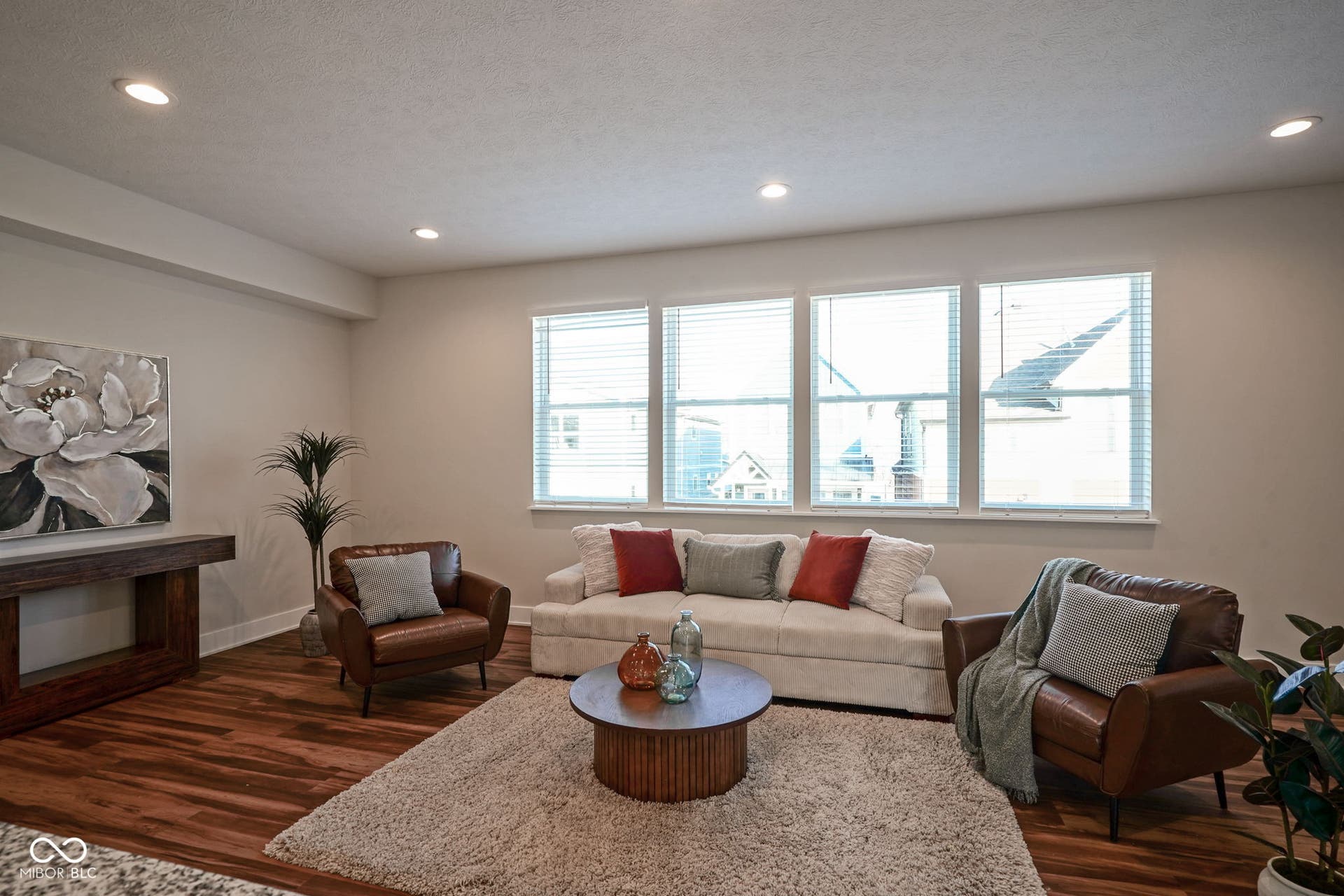 living area featuring dark wood-type flooring, recessed lighting, and a textured ceiling