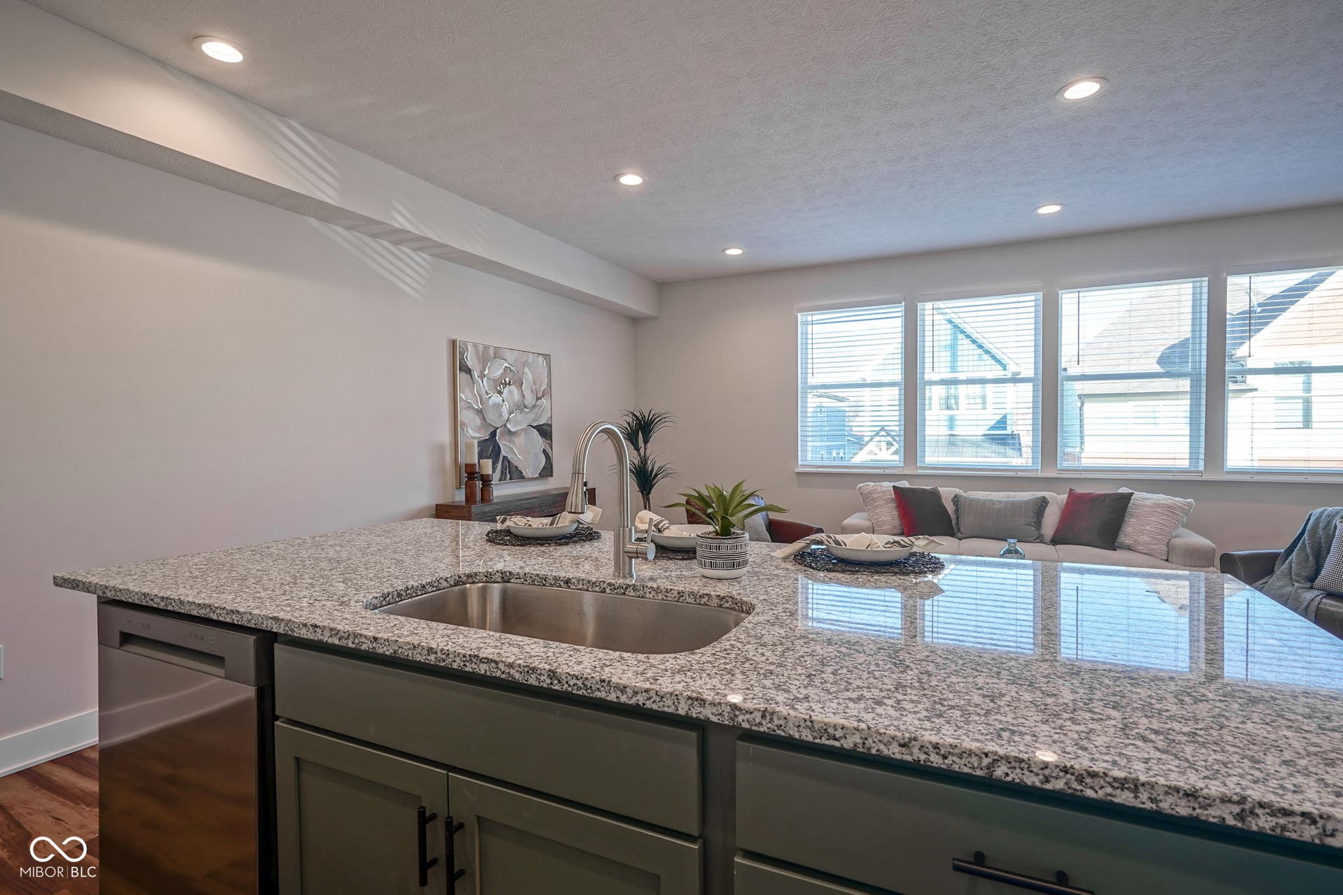 kitchen featuring open floor plan, light stone counters, stainless steel dishwasher, recessed lighting, and a textured ceiling