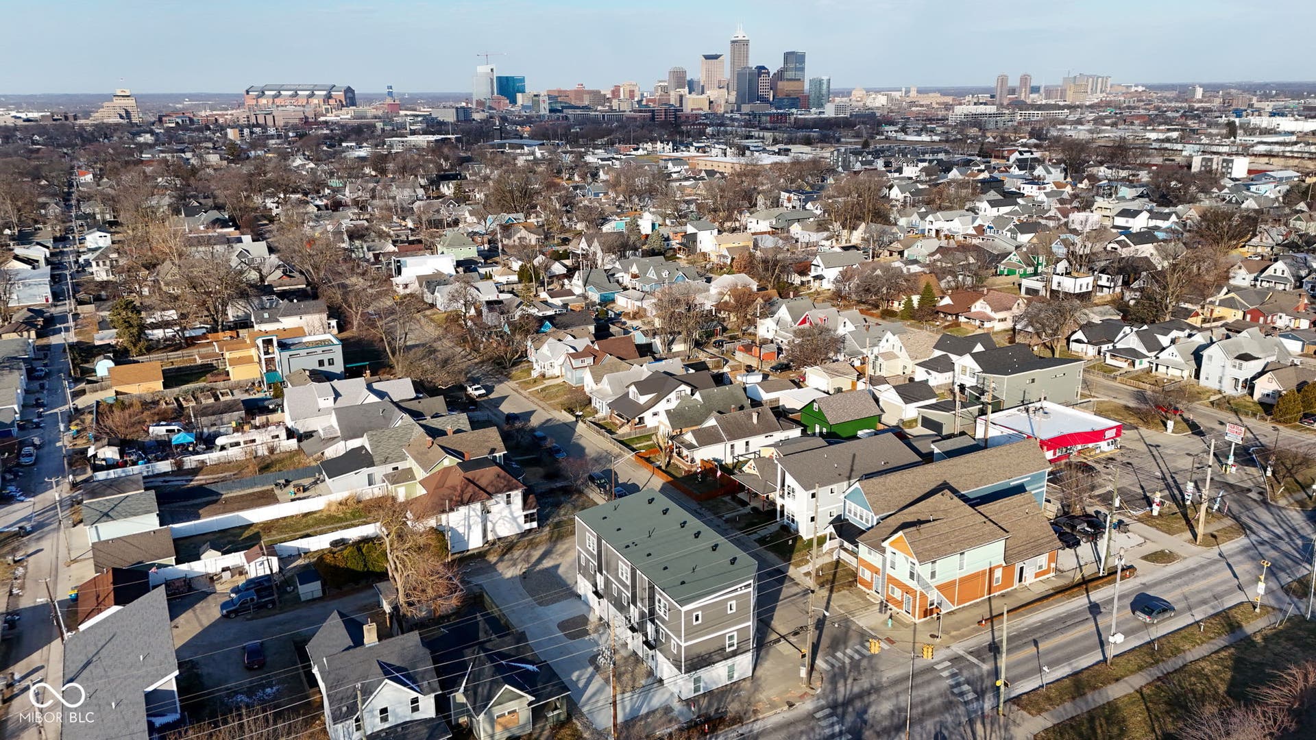 aerial view of property and surrounding area with nearby urban area