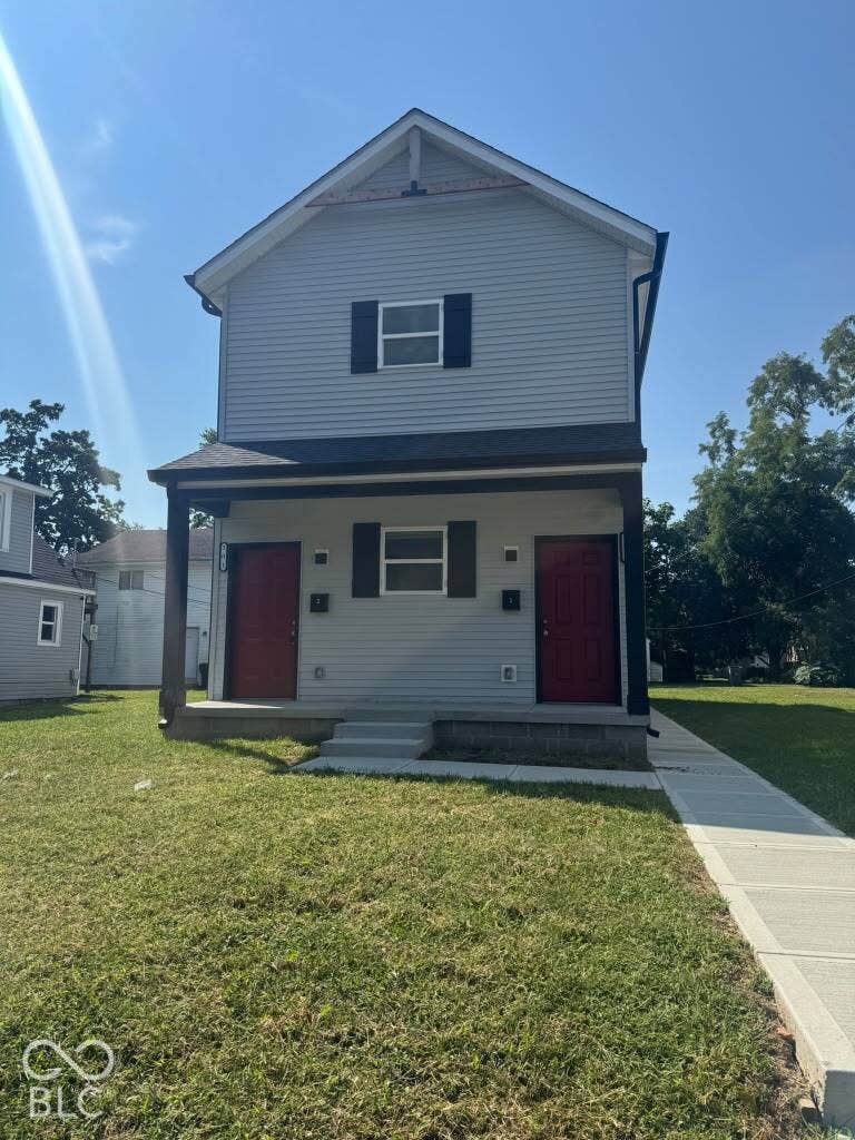 Two-story exterior with light gray siding and dark red entry doors