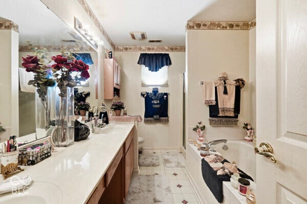 Extended vanity with dual sinks and a white countertop