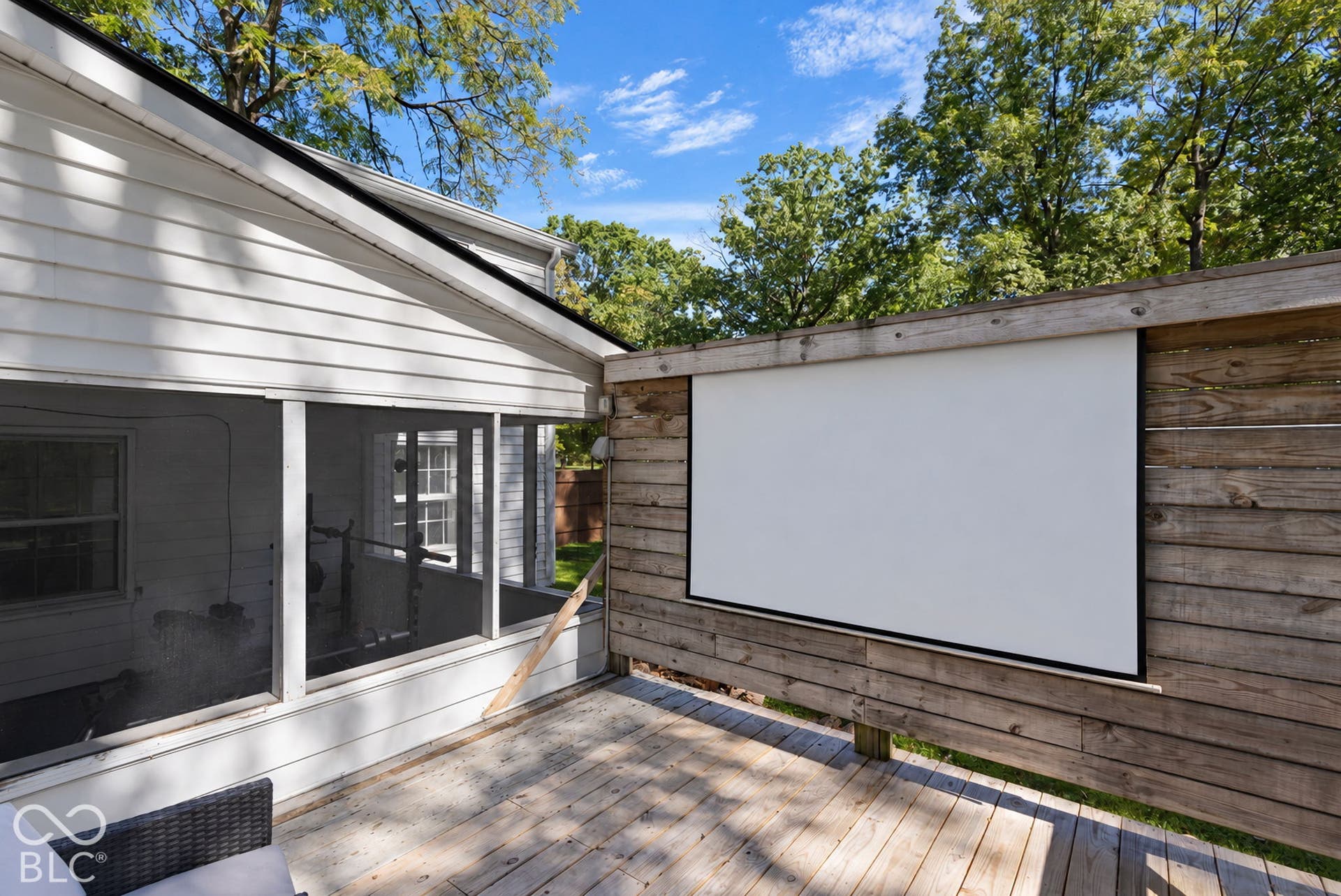 Wood-finish deck with a built-in projector screen great for hosting backyard parties or letting he kiddos sit and watch movies throughout the year