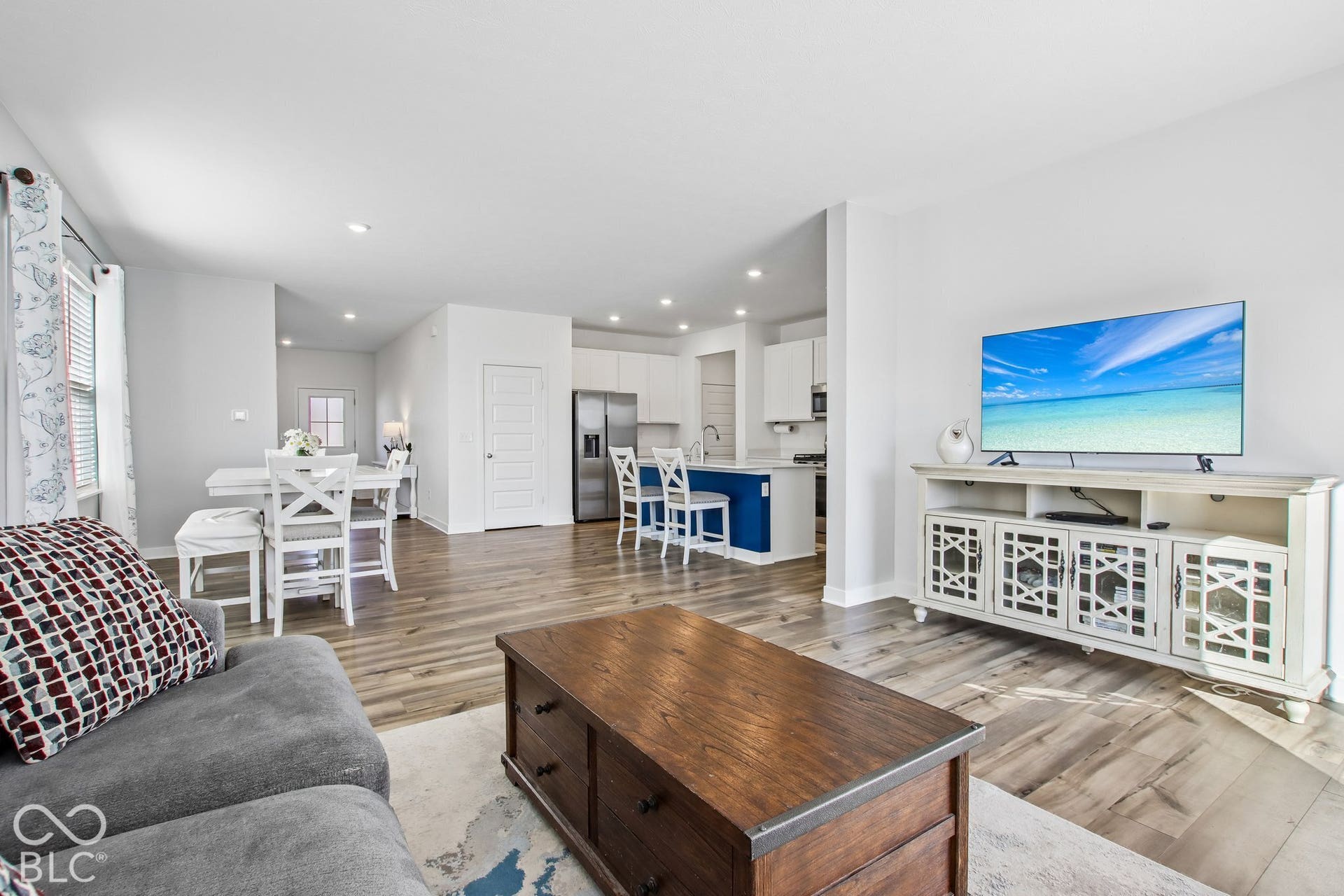 Wood-finish flooring throughout, recessed lighting, and a white interior paint palette