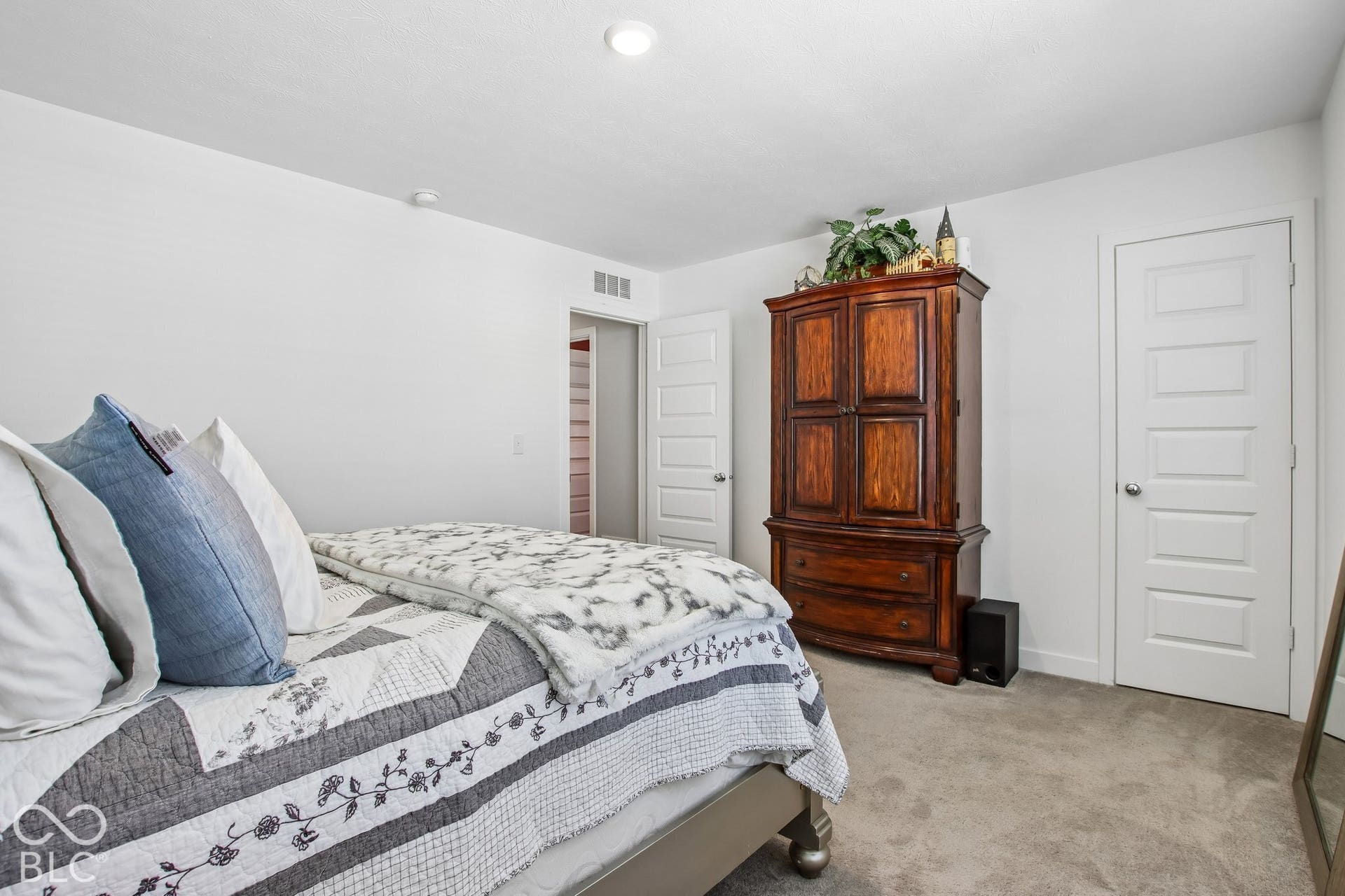 Recessed ceiling lighting, white walls, gray carpet flooring, and white paneled doors