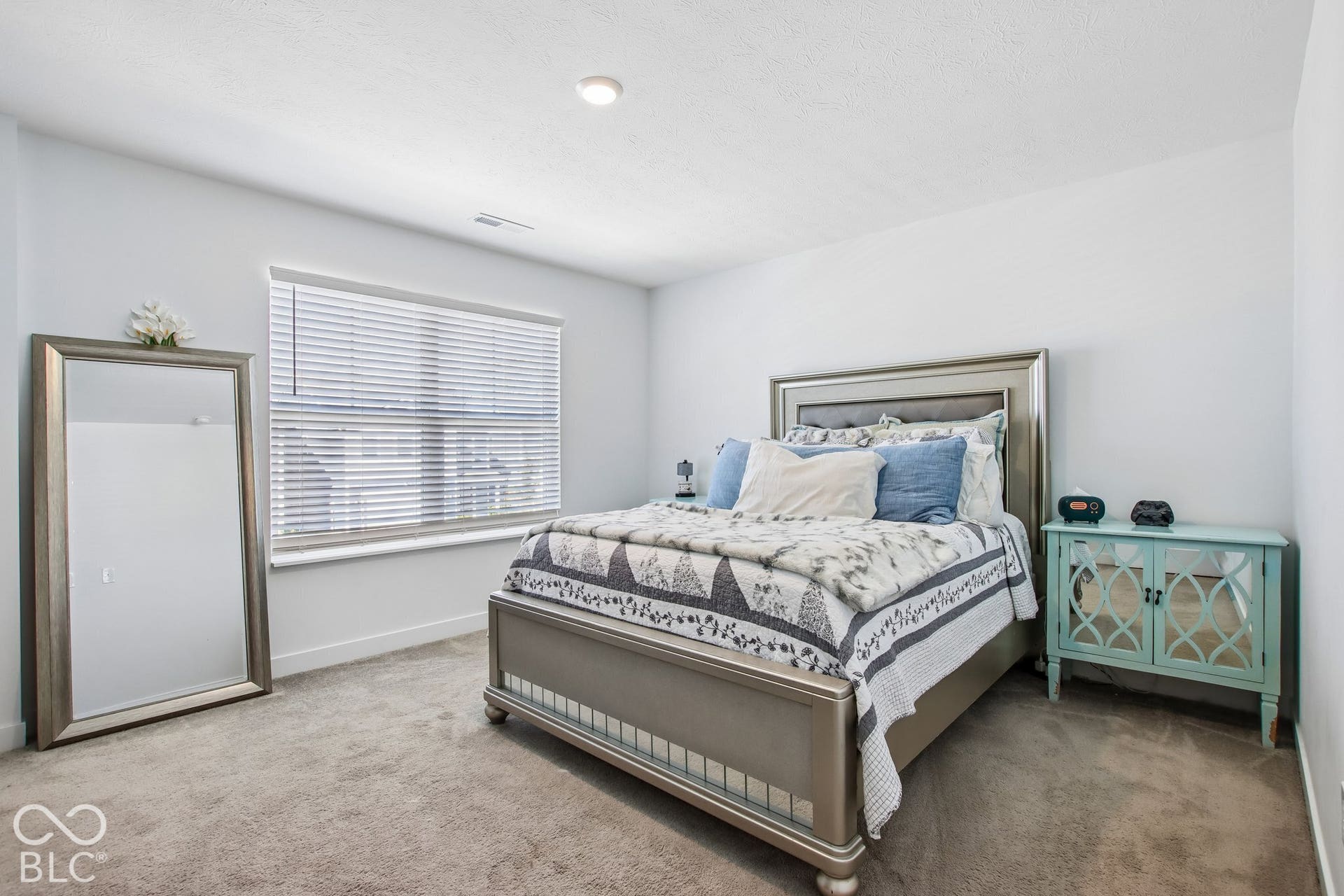 Recessed ceiling lighting, window with blinds, and light-toned wall paint