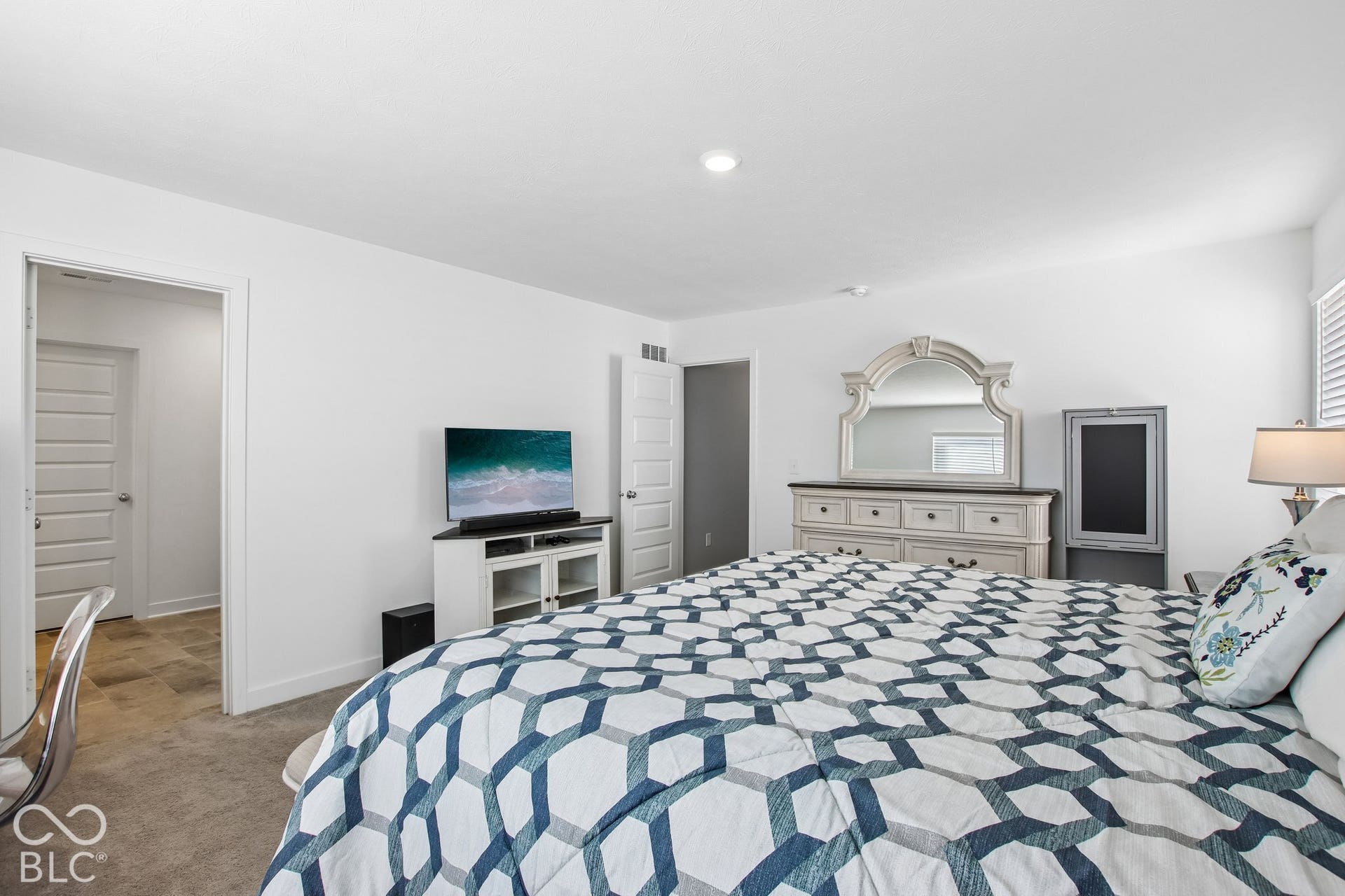 Recessed ceiling lighting, white interior doors, and neutral wall tones