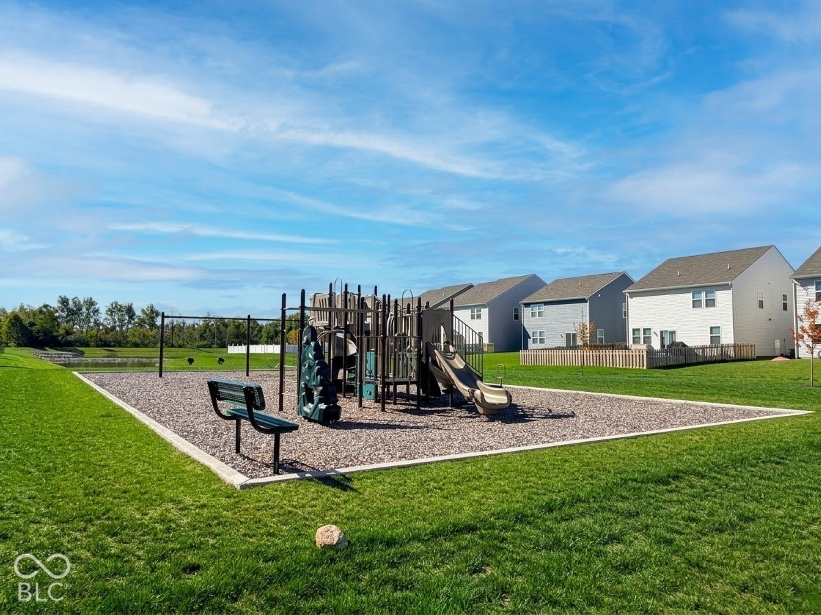 Community playground with multiple slides and swing sets set