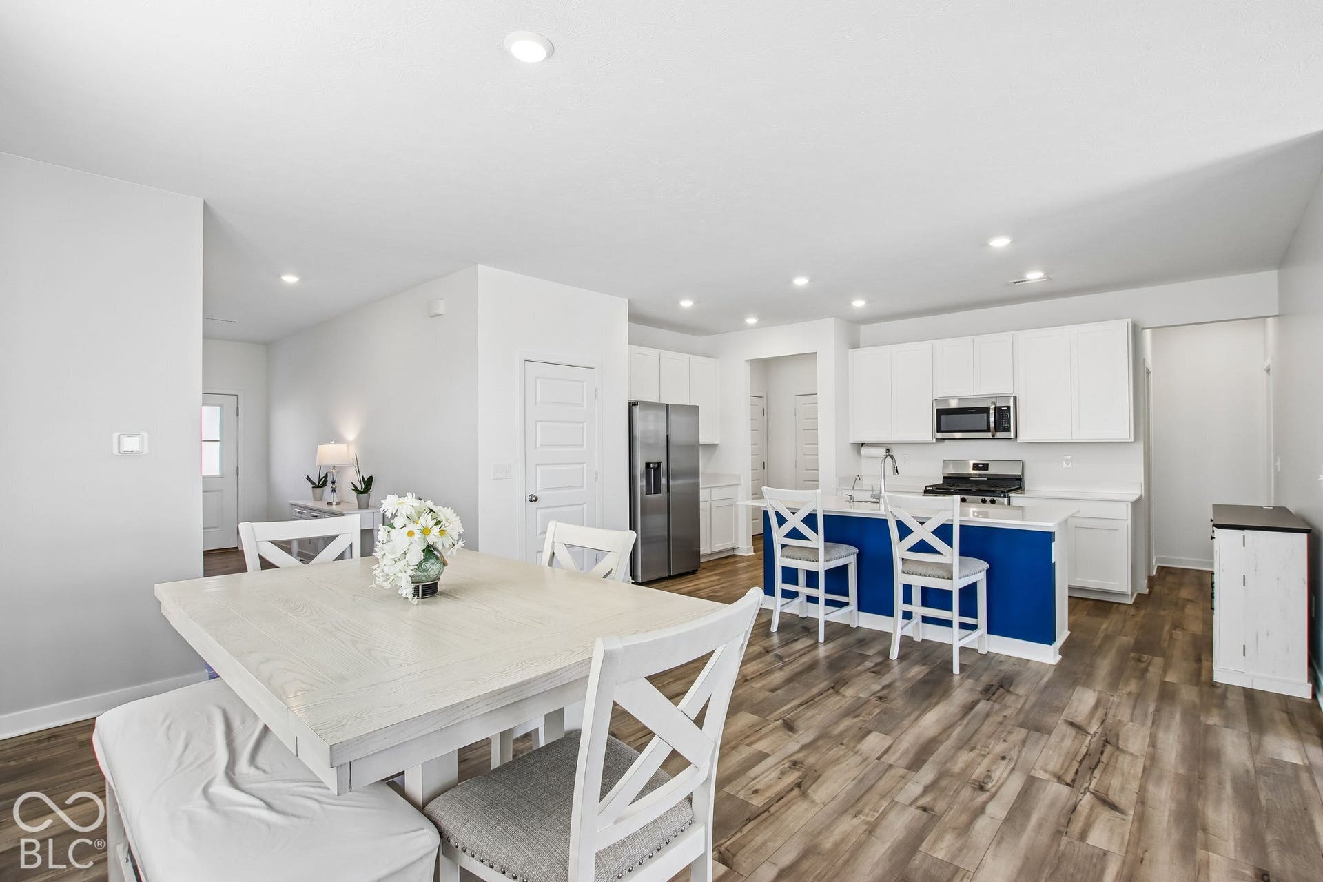 Open-concept living area featuring wood-finish flooring