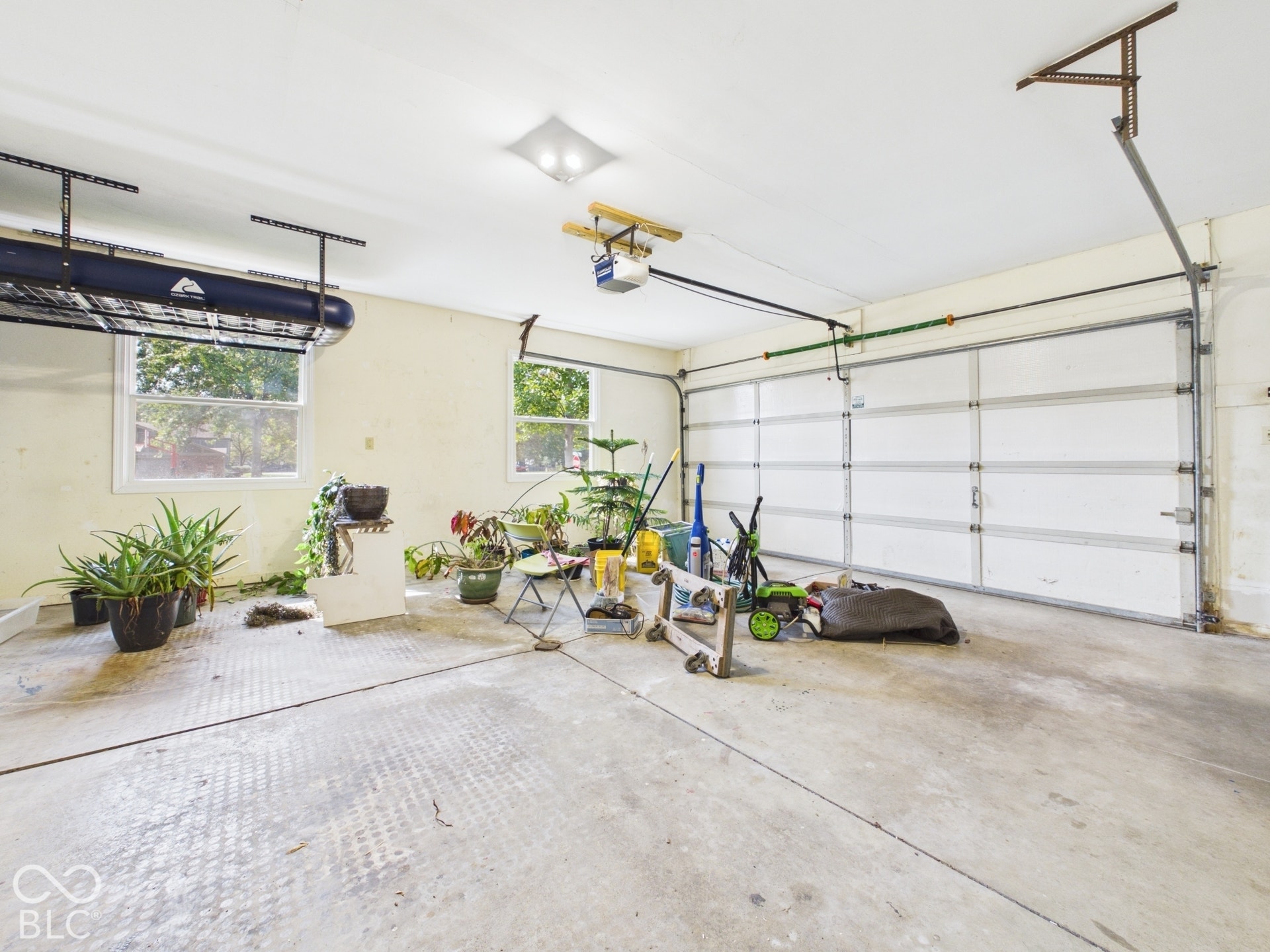 Two-car garage with multiple windows and overhead lighting