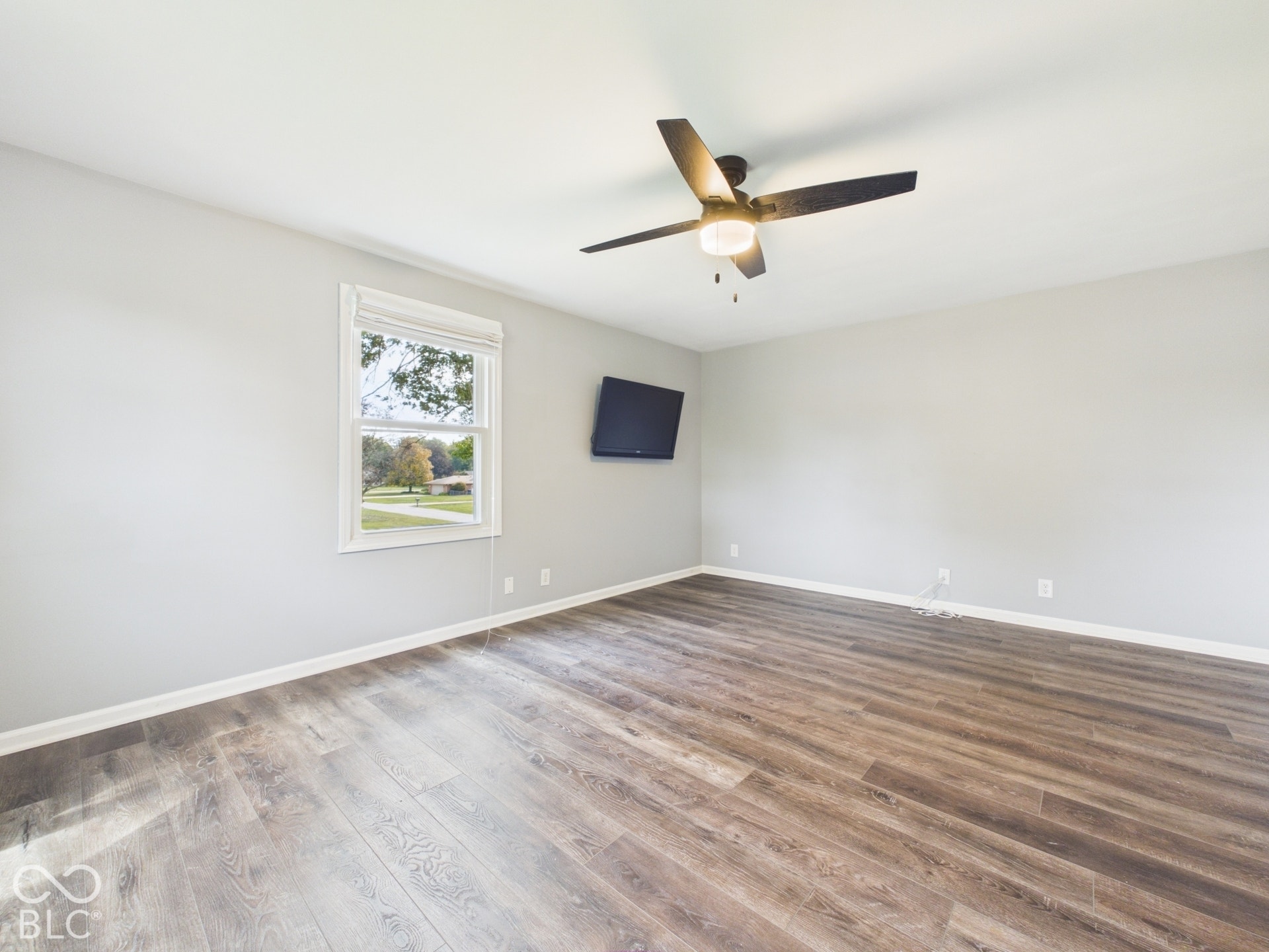 Wood-finish flooring throughout, complemented by a white trim