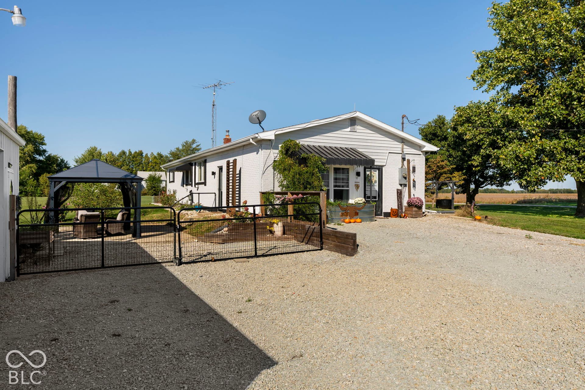 Charming manufactured home situated on expansive grounds with mature landscaping and established trees