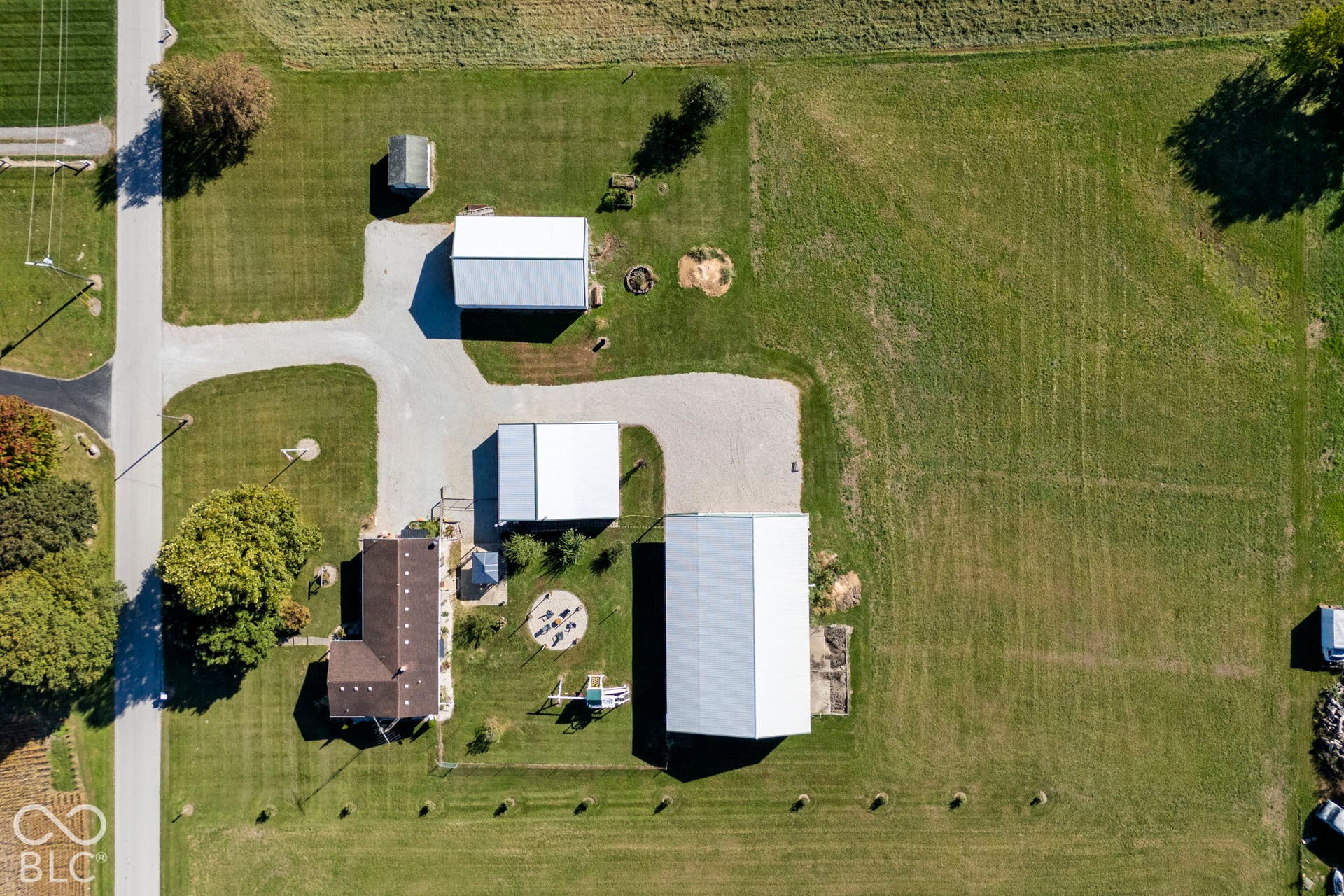 Expansive lot featuring a primary residence, multiple outbuildings, and extensive green space
