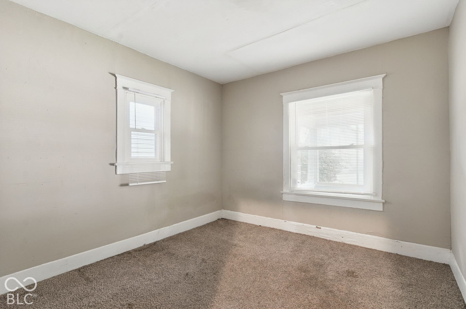 Neutral-toned walls complement the carpeted flooring