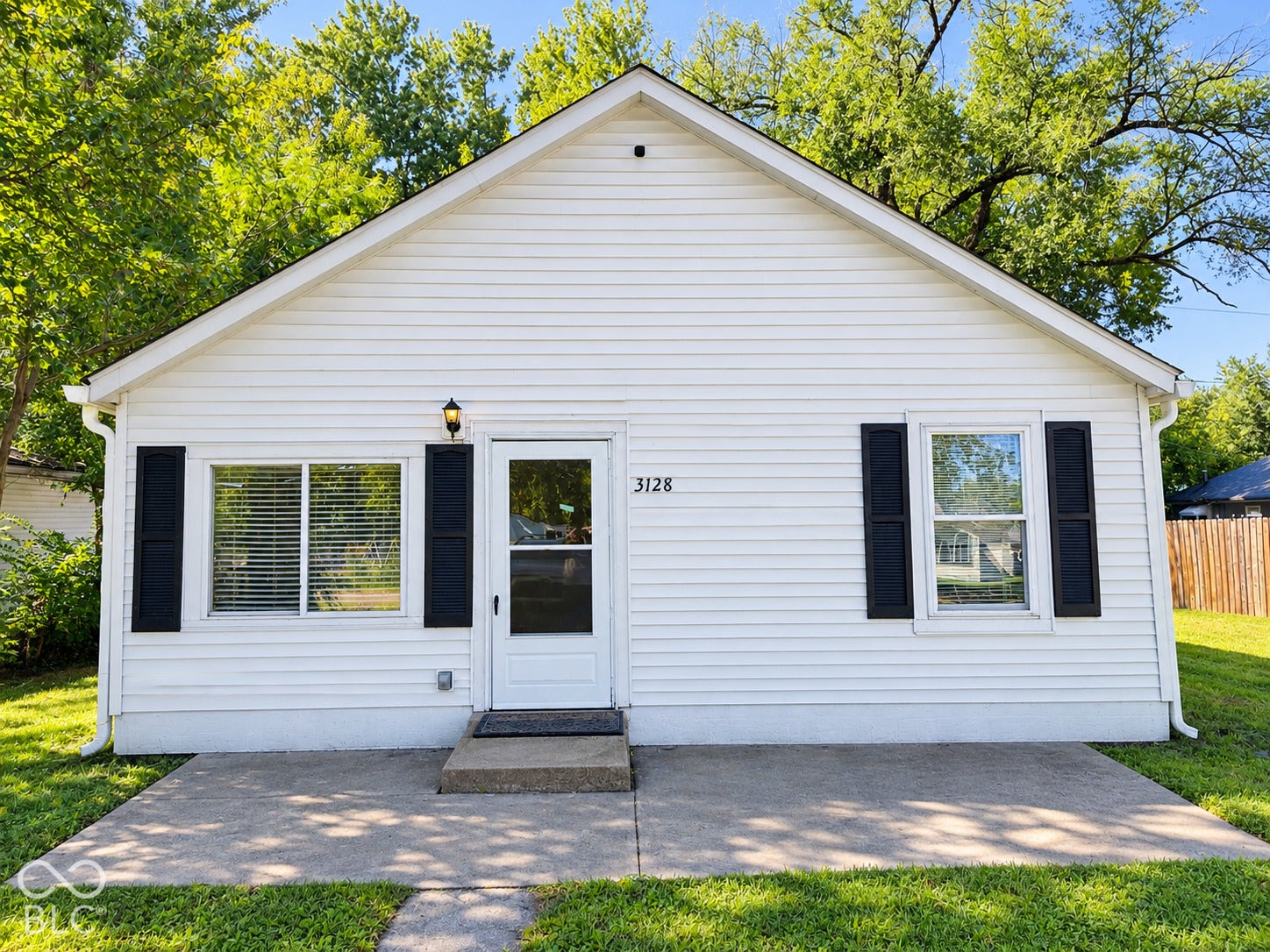 White vinyl siding exterior with an A-frame roof