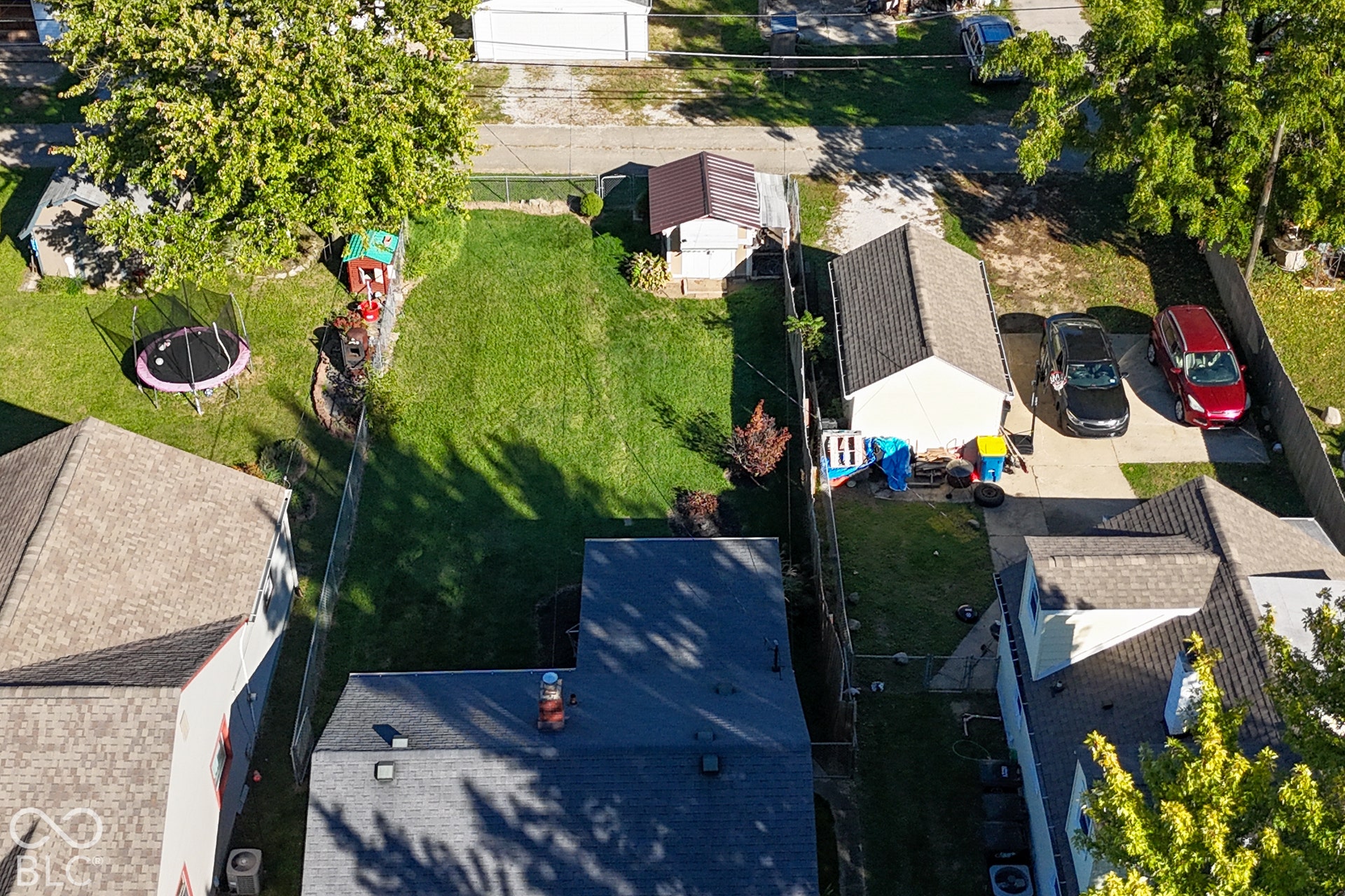 Expansive grassy yard with mature trees