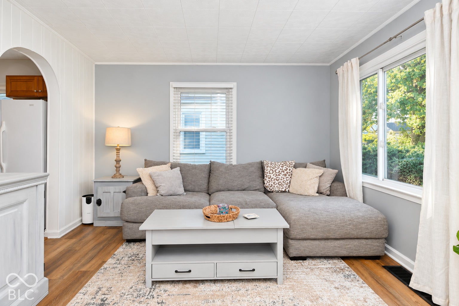 Wood-finish flooring, light gray wall paint, and white trim accents