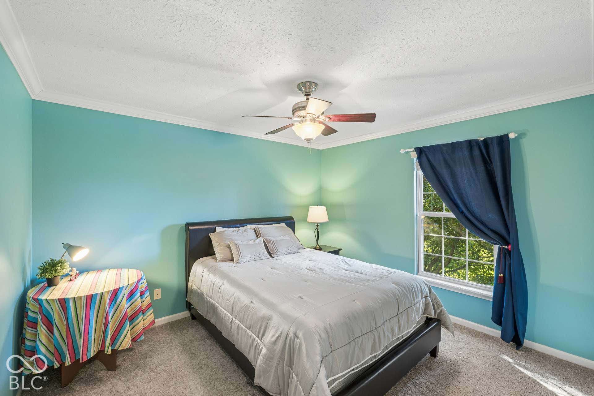 Another spacious upper-level bedroom provides comfortable accommodations for family or guests.