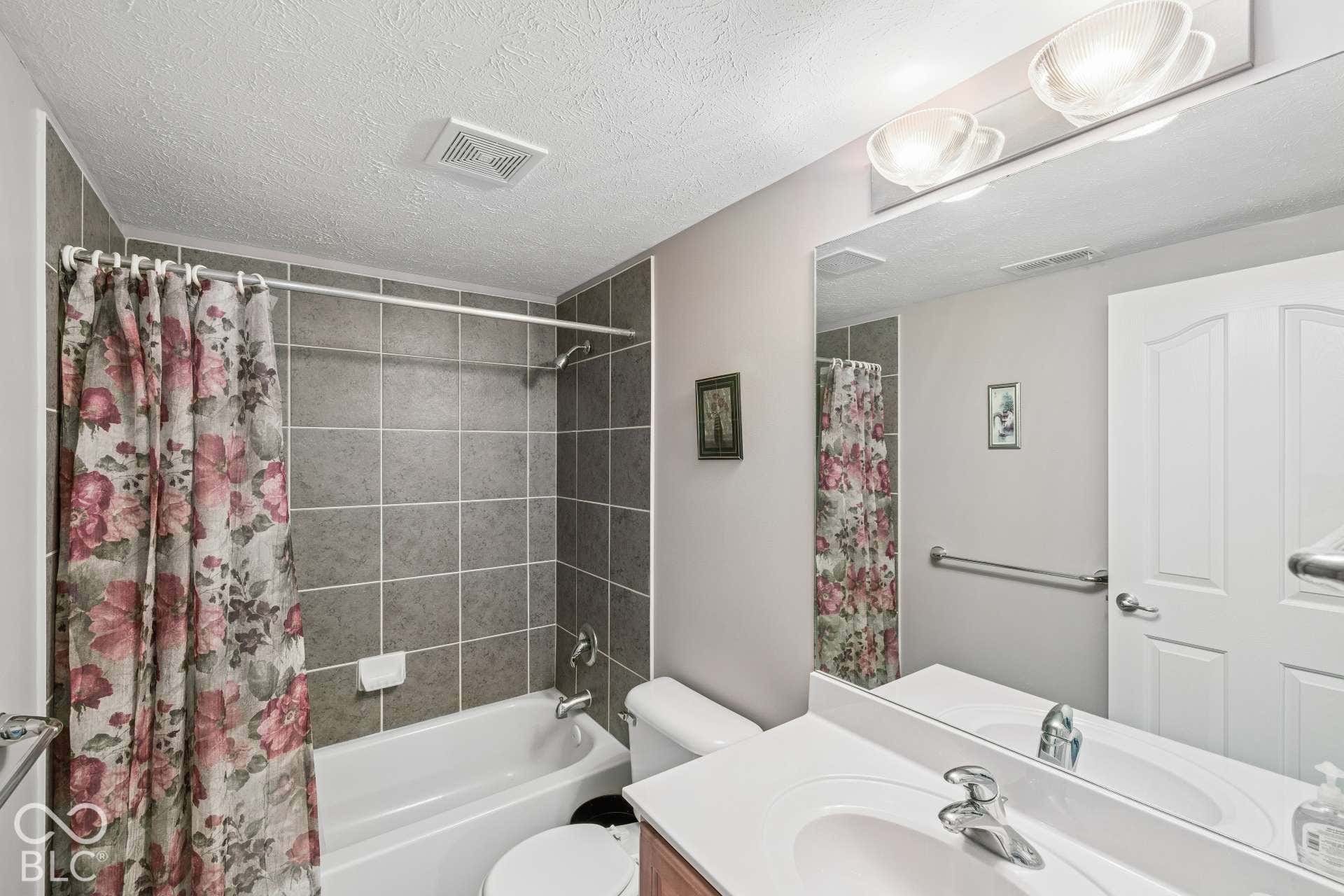 Full bathroom adds convenience to the fifth bedroom and finished lower-level living spaces.