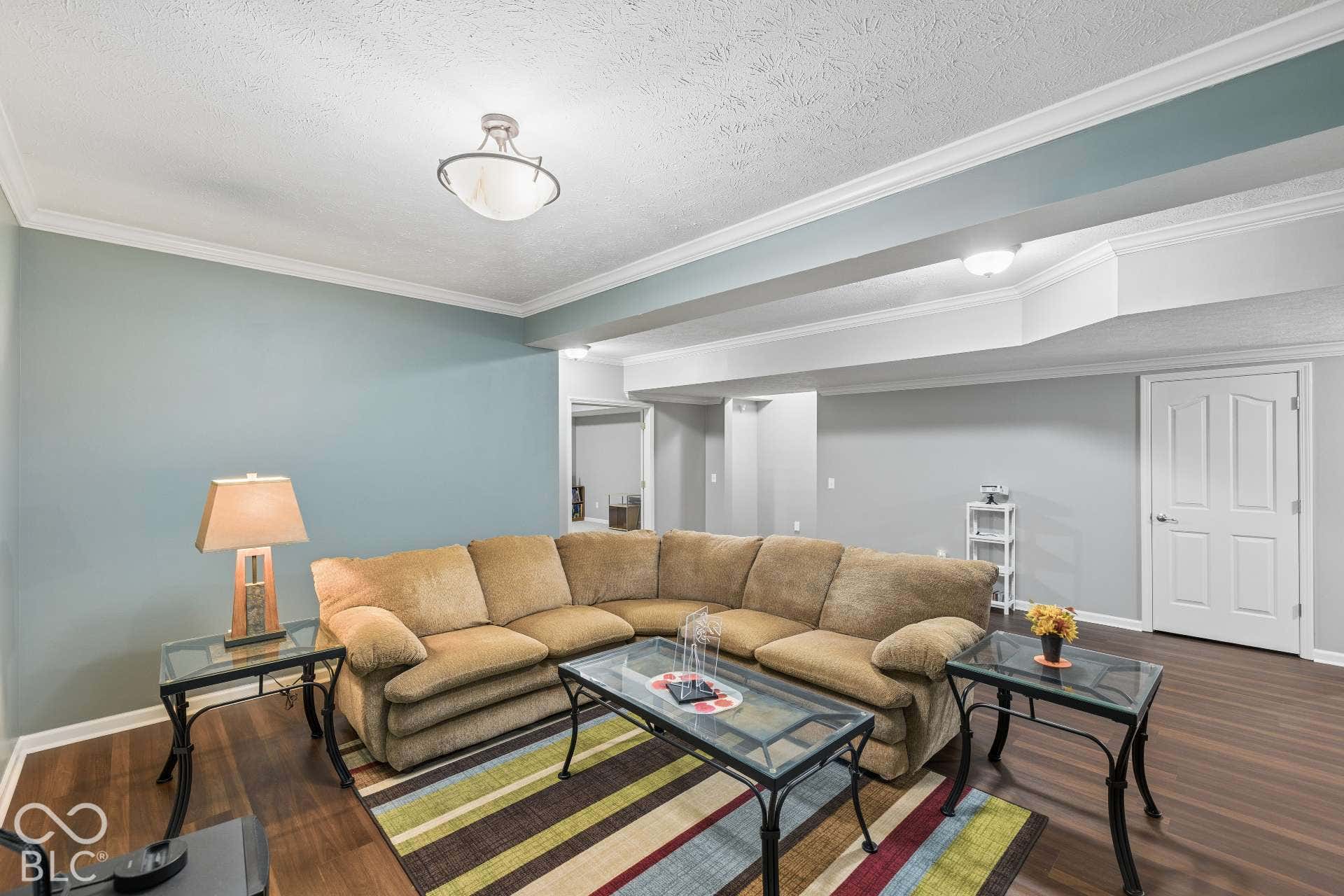Comfortable lower-level gathering area provides another place to relax, watch movies or spend time with family and friends.