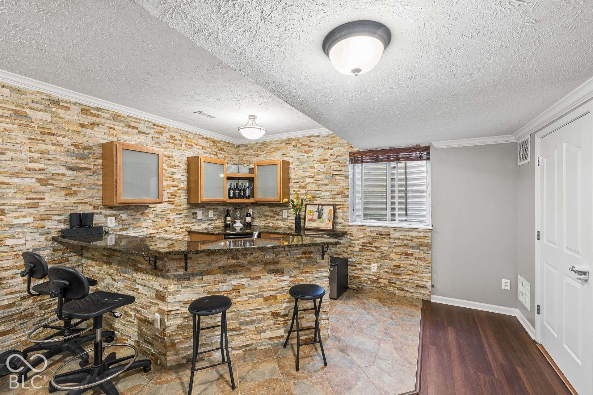 Finished basement includes a wet bar, creating a great setup for entertaining and casual gatherings.