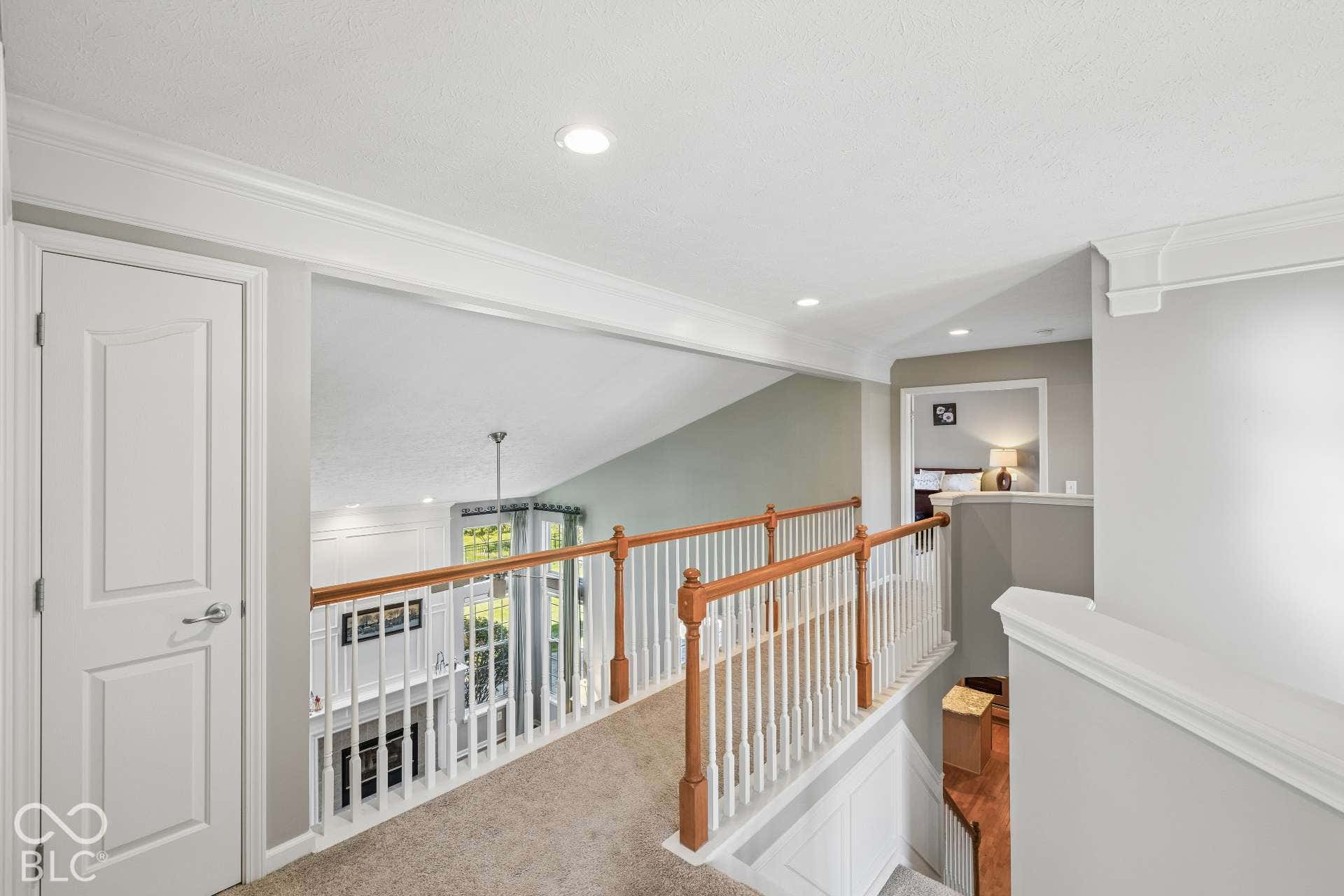 Open landing connects the bedrooms while overlooking the main level and adding to the home's spacious feel.
