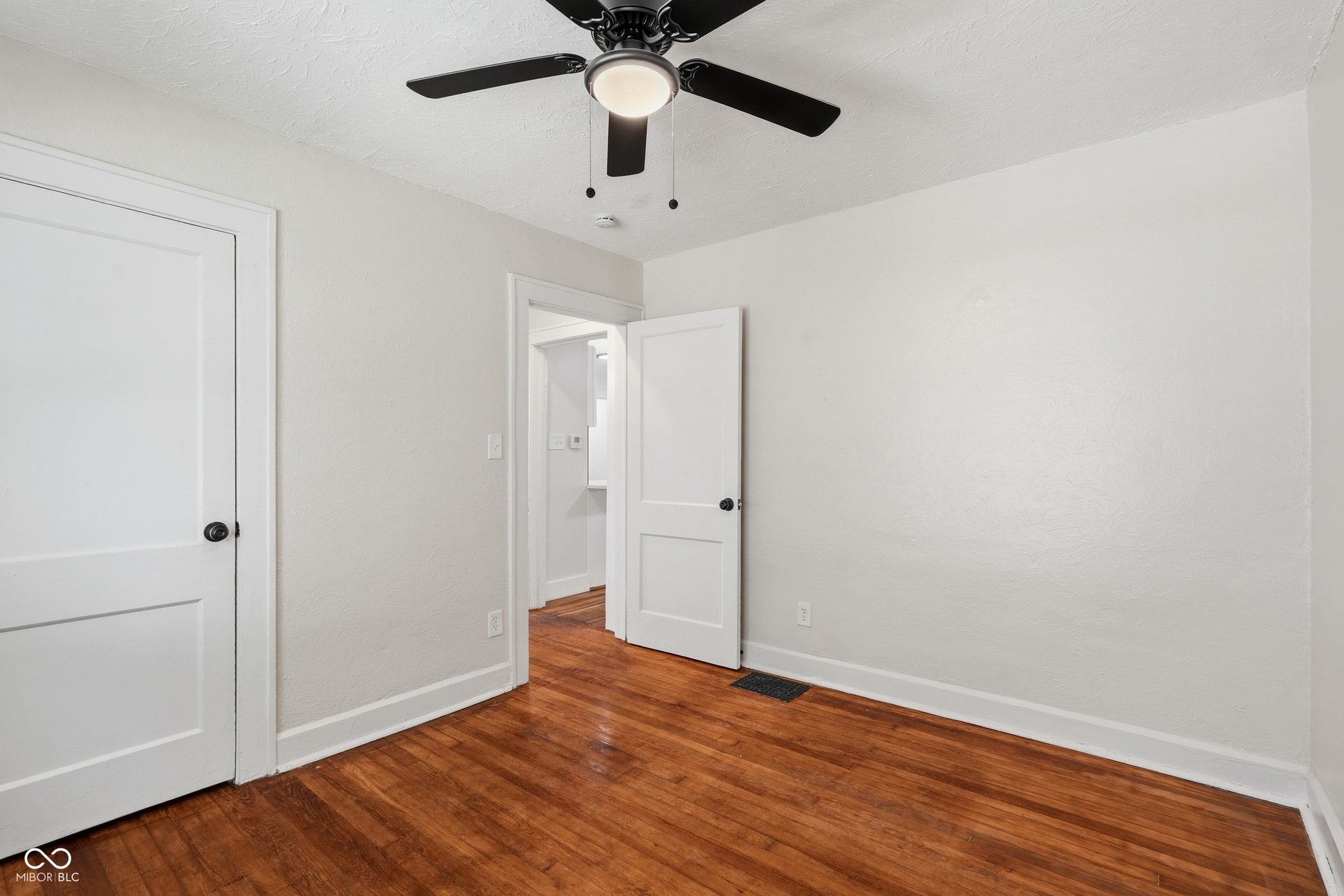 Hardwood-finish flooring with white baseboards