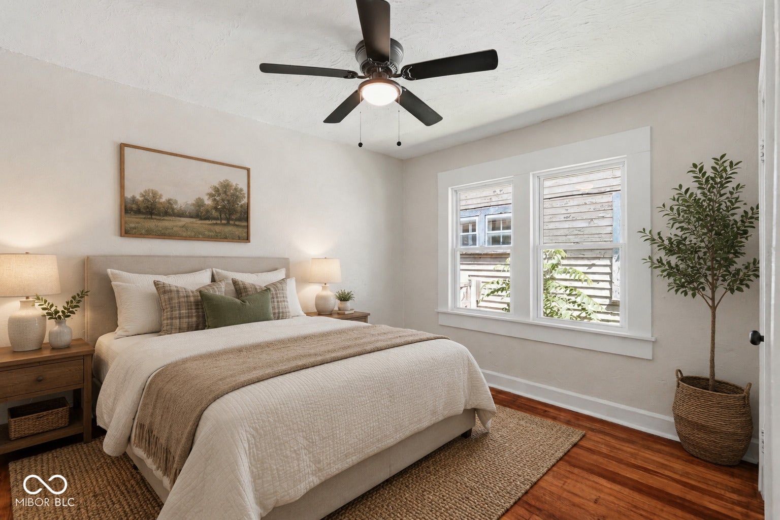 Virtually Altered - Hardwood flooring throughout featuring a ceiling fan, dual windows with white trim, and light-toned walls - **VIRTUALLY STAGED**