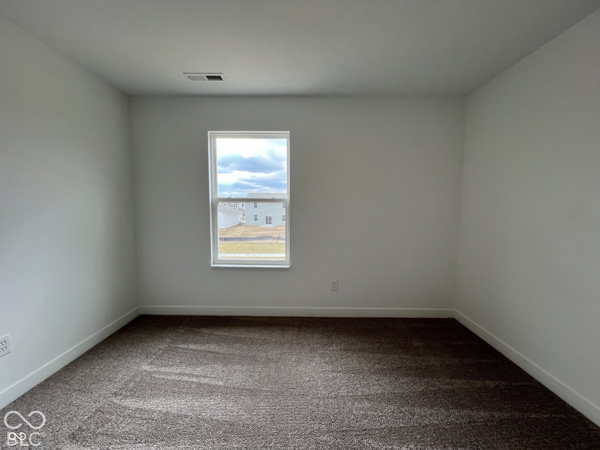 Neutral wall color, window with exterior exposure, and carpet flooring