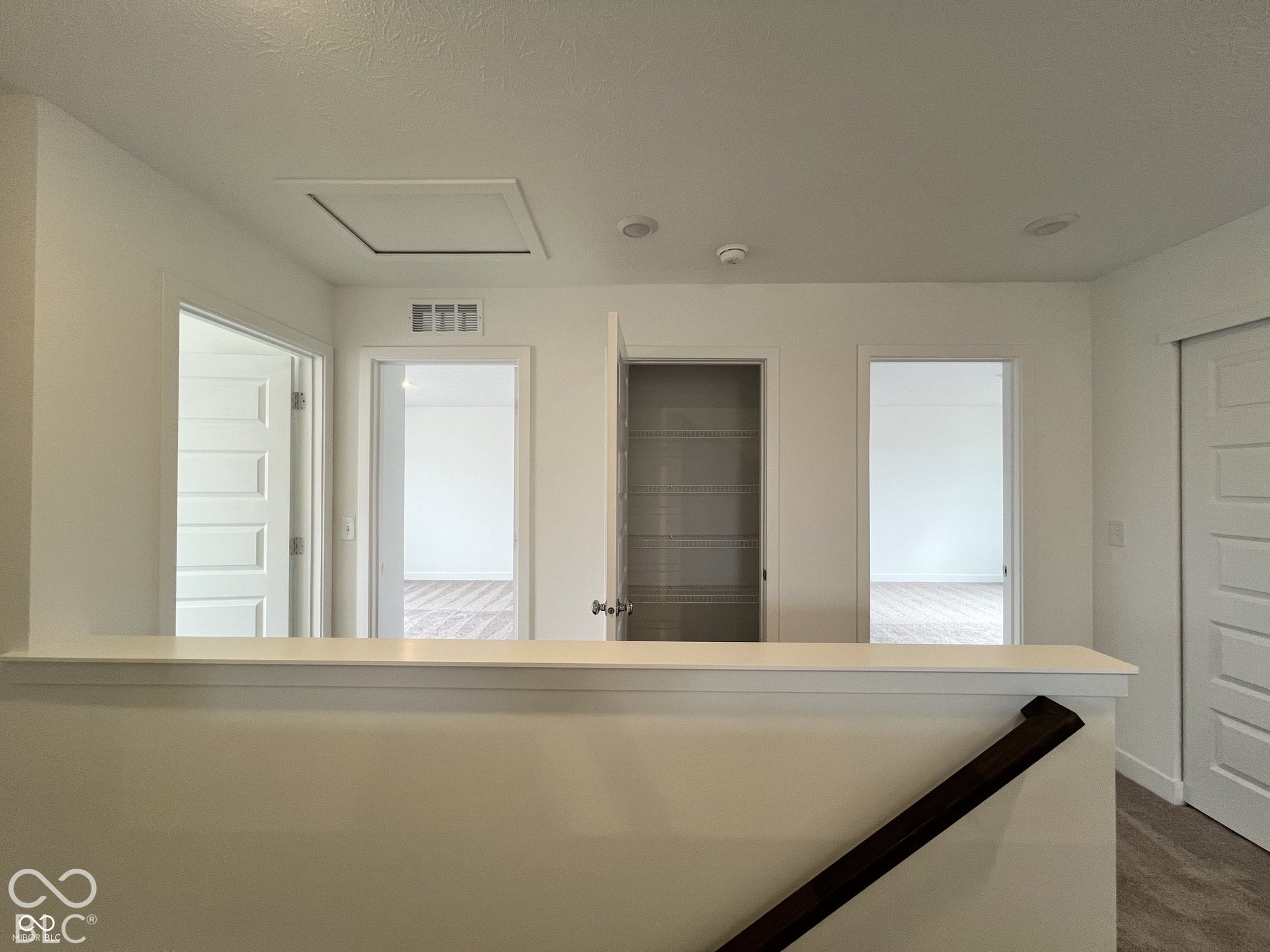 Hallway featuring recessed lighting, a built-in wire-shelf closet, and carpeted flooring