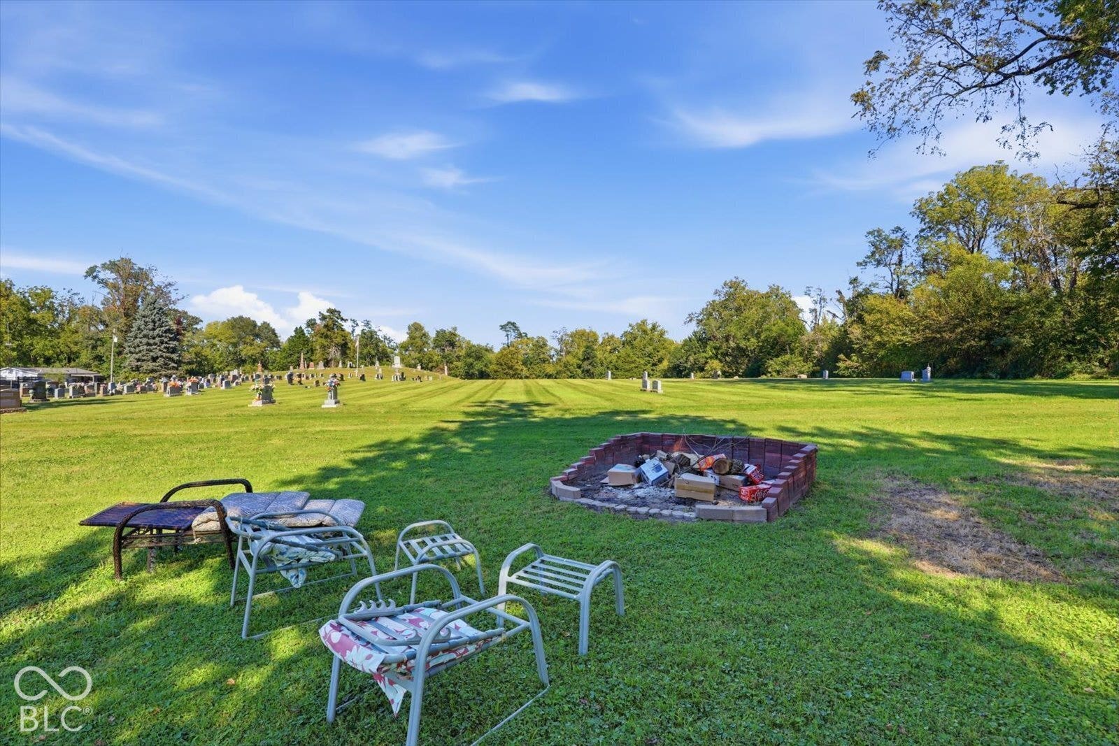 Expansive manicured lawn with mature trees providing natural shade and privacy