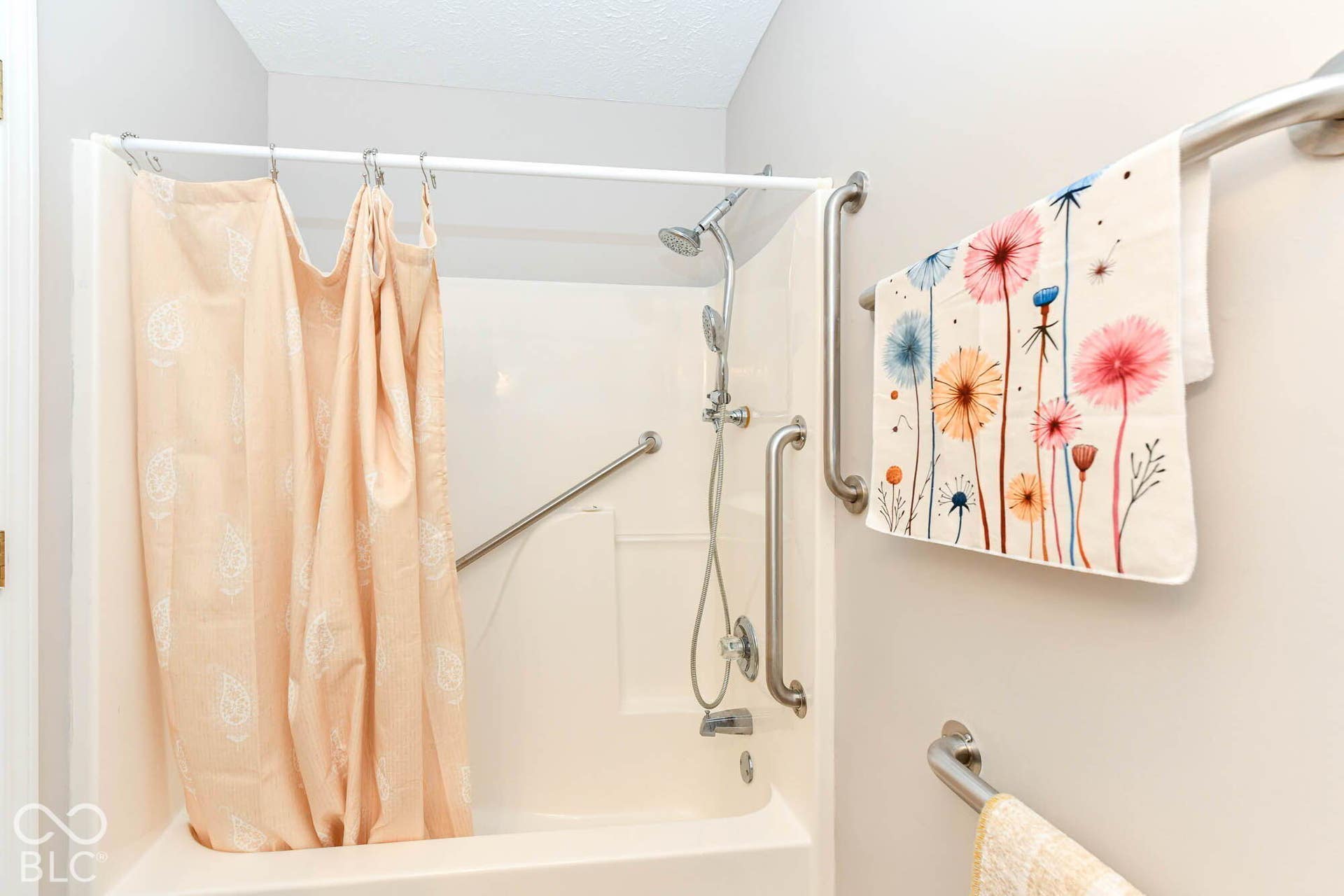 Tub and shower combination with a handheld shower fixture