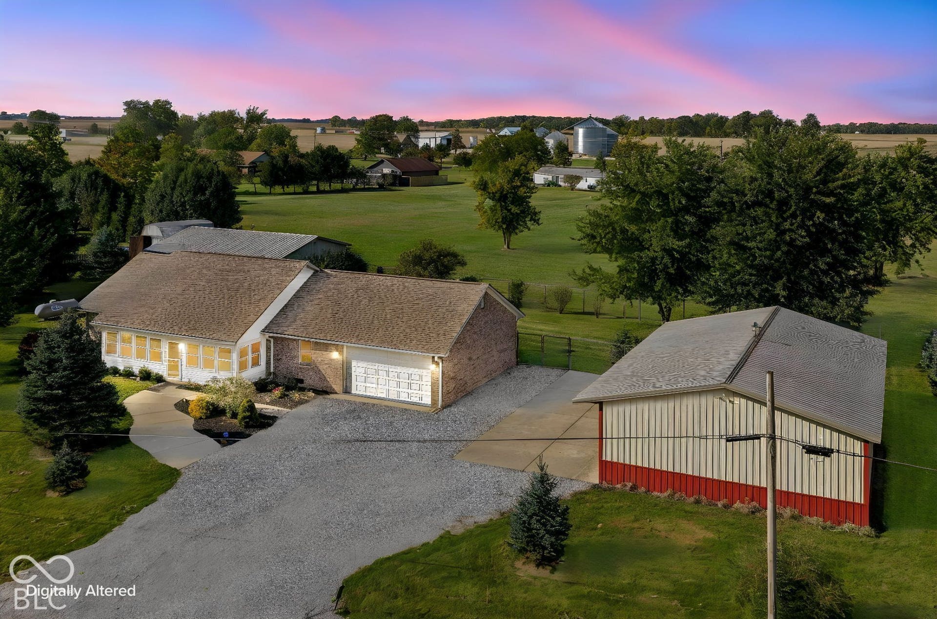 Single-story residence with a brick and siding exterior, attached garage, and gravel driveway