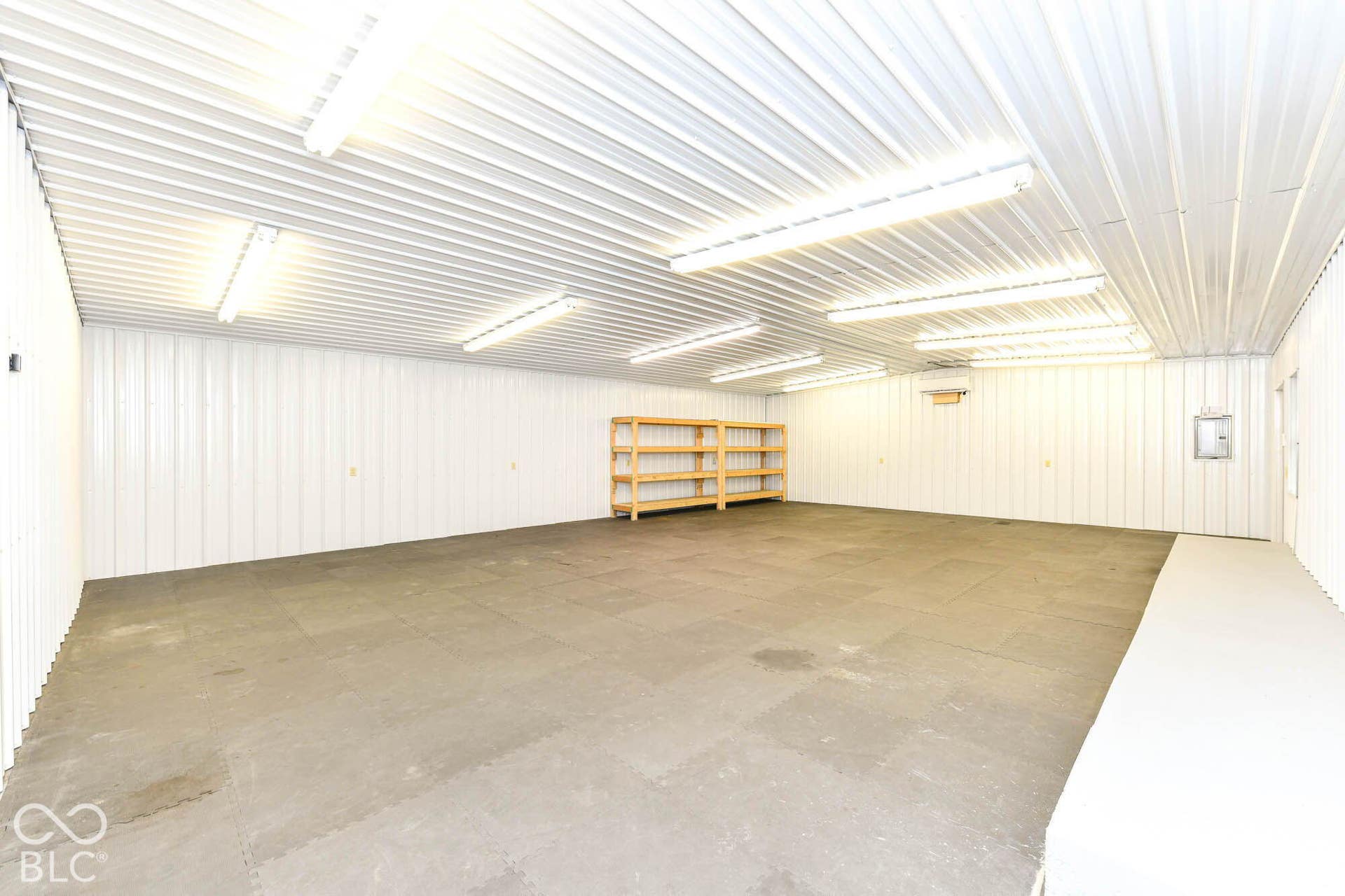 Expansive interior space featuring corrugated metal walls and ceiling