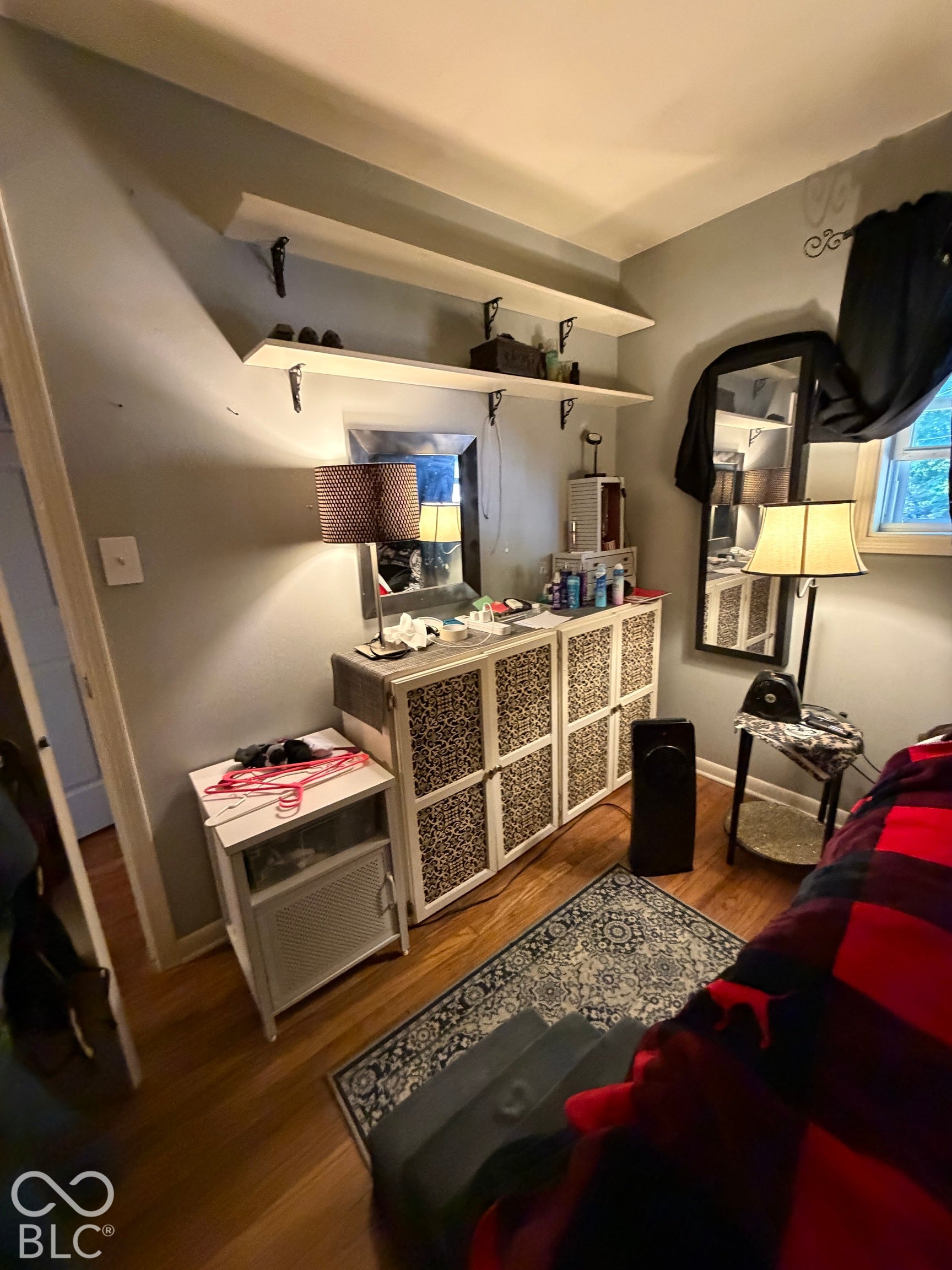 Wood-finish flooring with light gray wall paint and overhead lighting