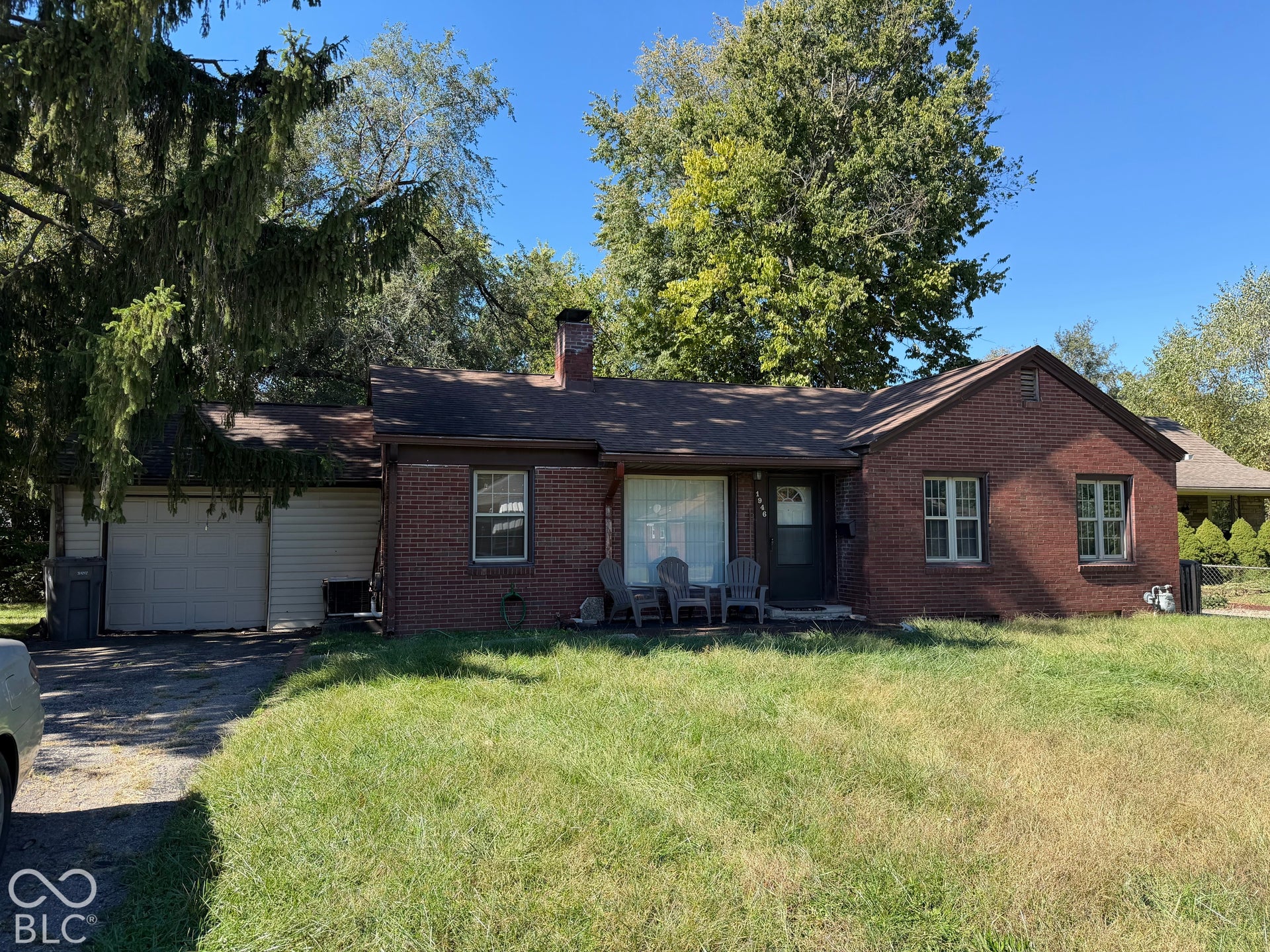 Brick exterior with a gabled roofline and an attached garage