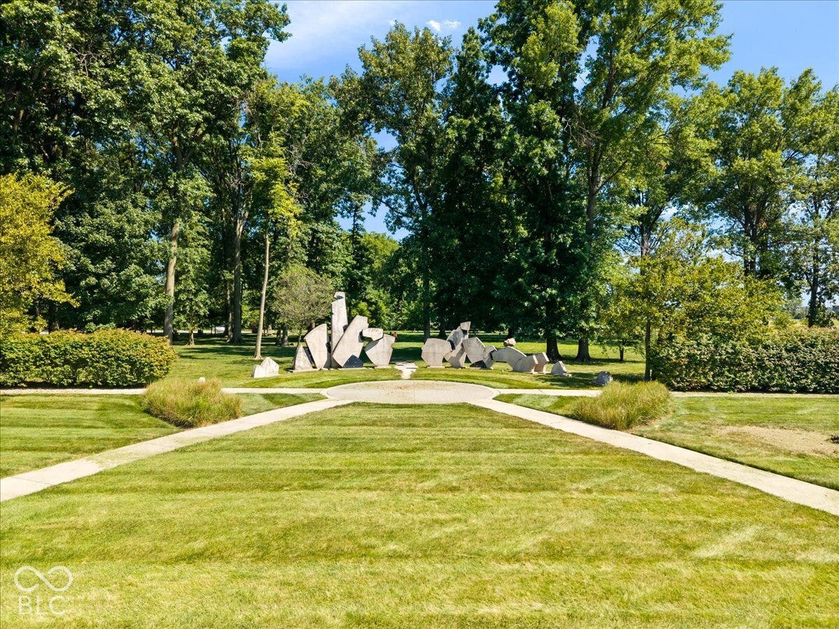 Expansive lawn with concrete pathways and mature trees
